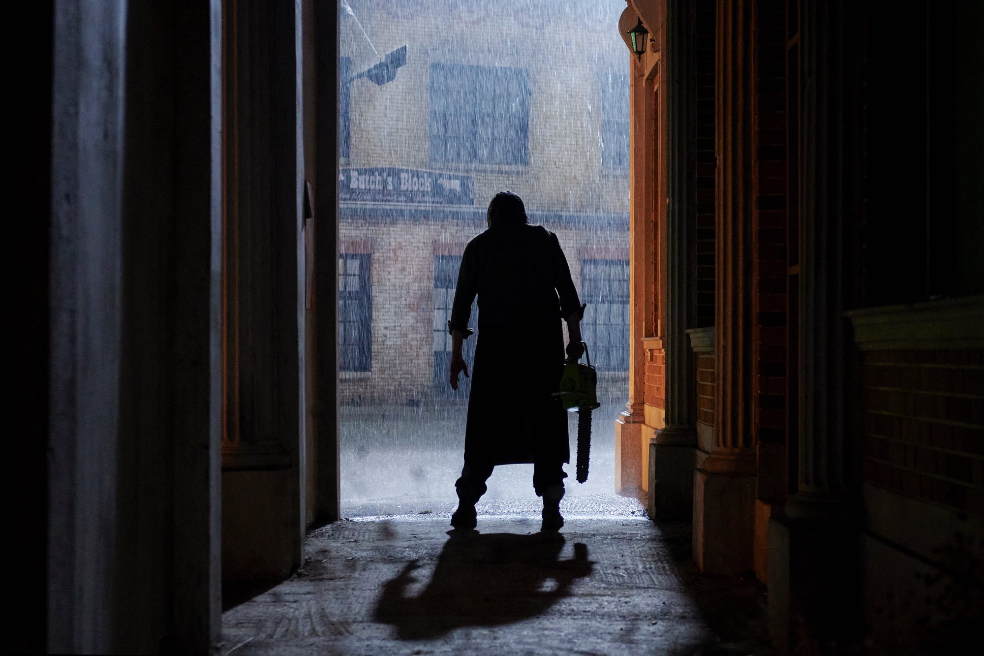 'Texas Chainsaw Massacre' post-credits Mark Burnham as Leatherface standing in front of a rainy background