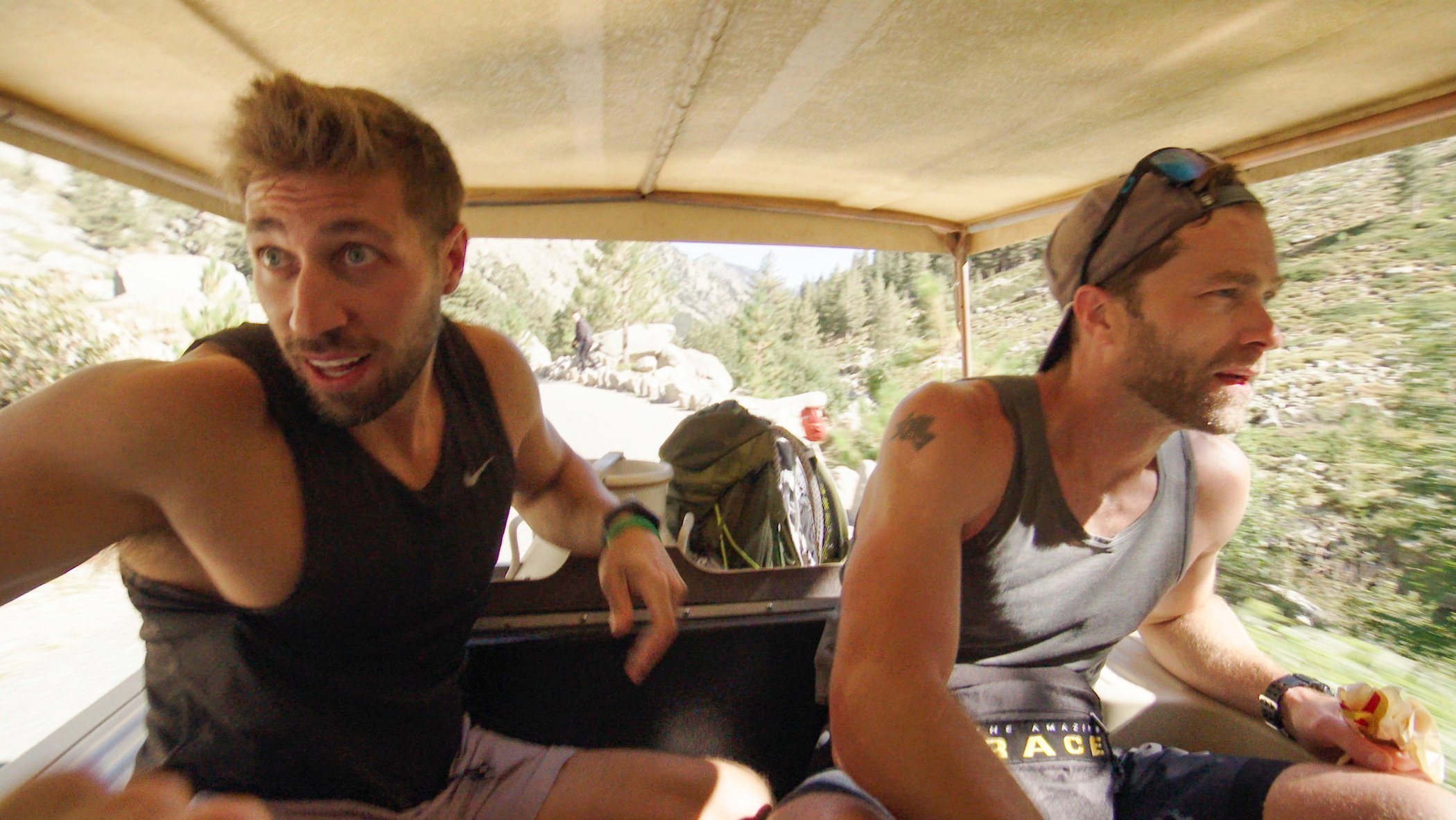 Ryan Ferguson and Dusty Harris riding in a vehicle looking stressed on 'The Amazing Race' Season 33 Episode 6