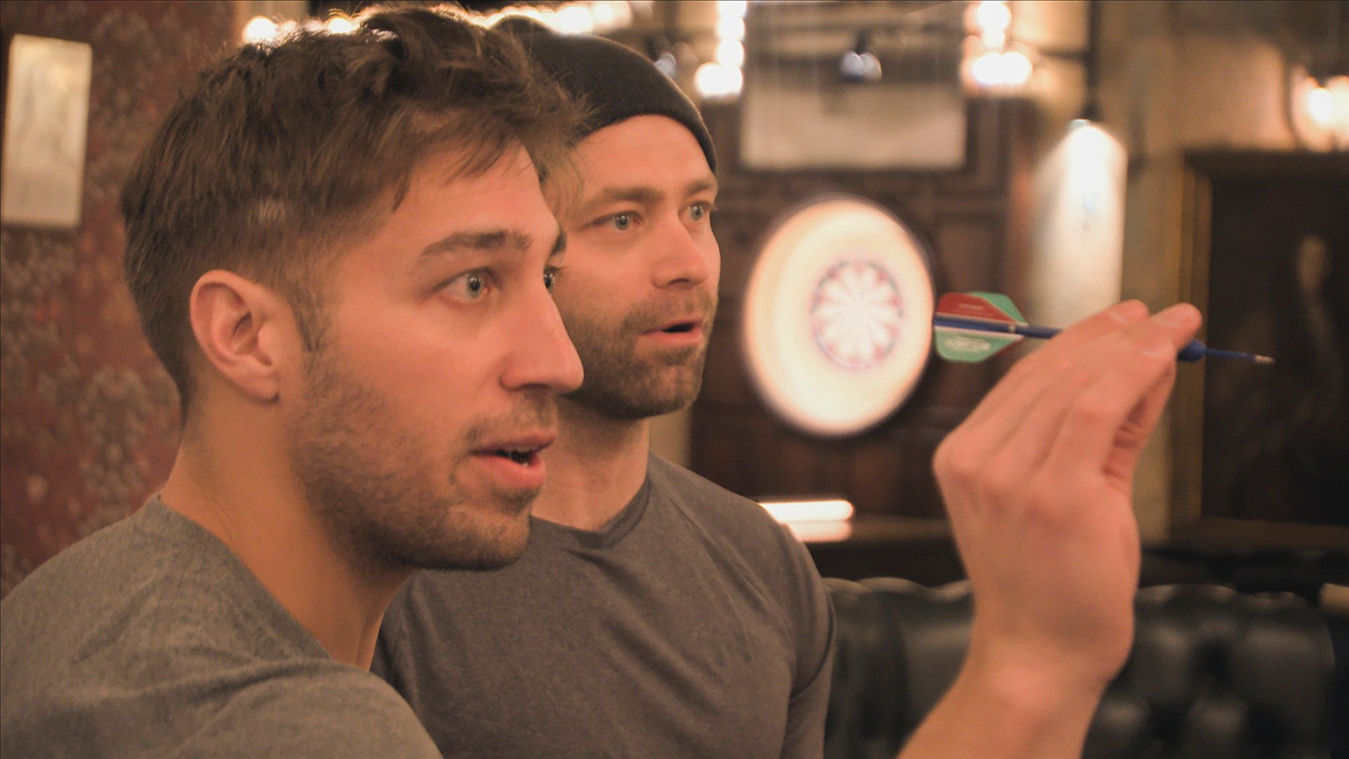 Ryan Ferguson and Dusty Harris playing darts in 'The Amazing Race' Season 33