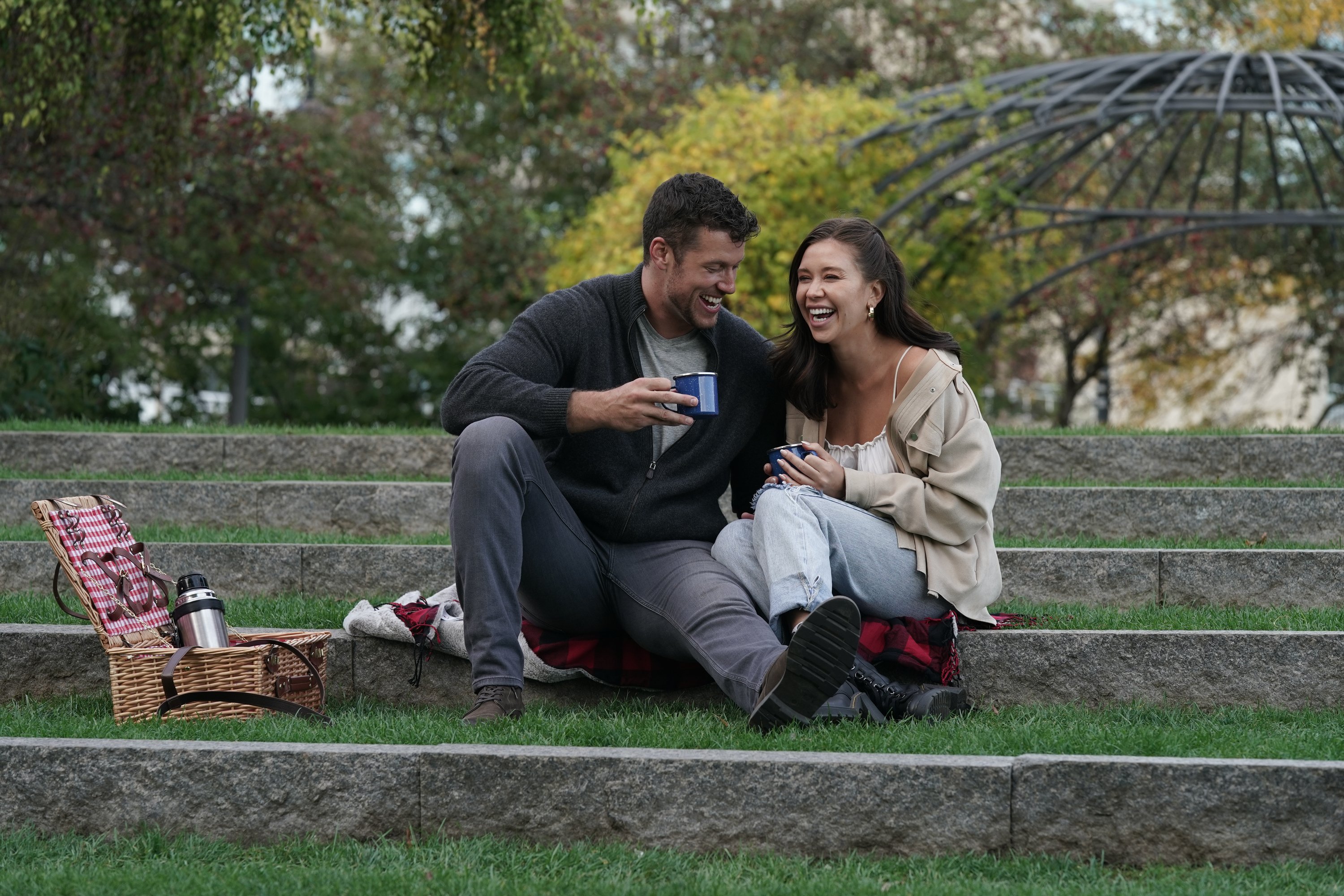 Is The Bachelor on tonight? Yes, and this image shows Clayton Echard and Gabby Windey sitting outside enjoying a cup of coffee together.