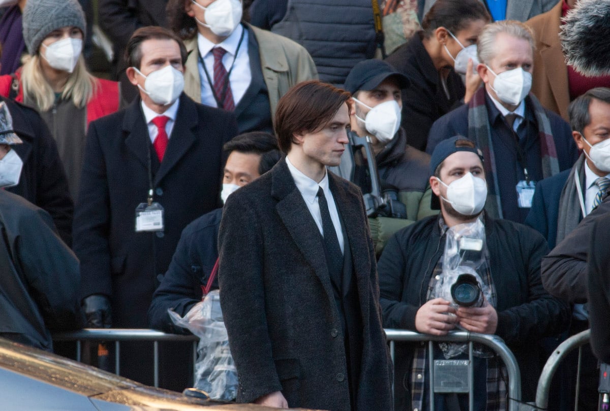 British actor Robert Pattinson films a scene for 'The Batman' movie in a black suit and coat