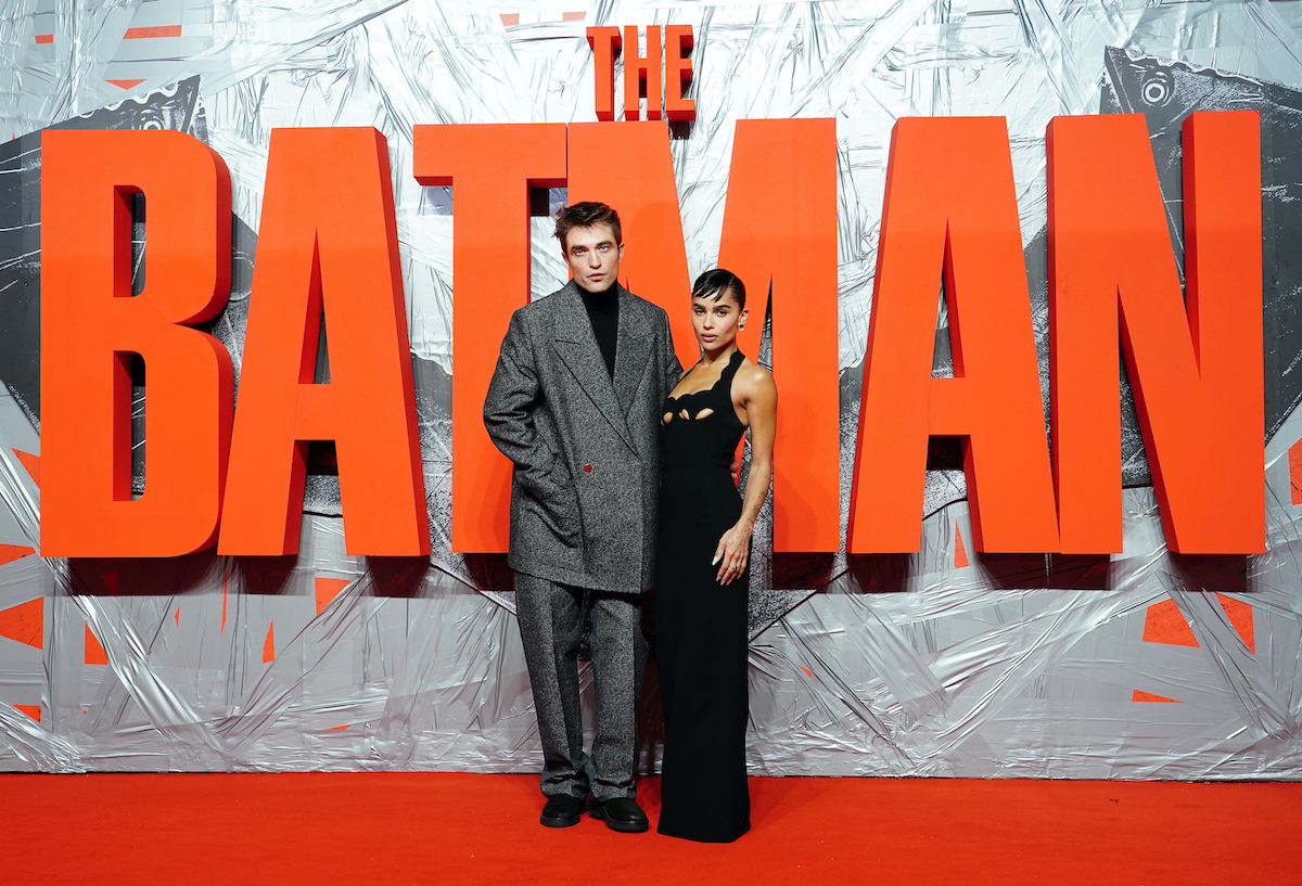 Robert Pattinson and Zoe Kravitz pose in front of ‘The Batman’ logo on the red carpet
