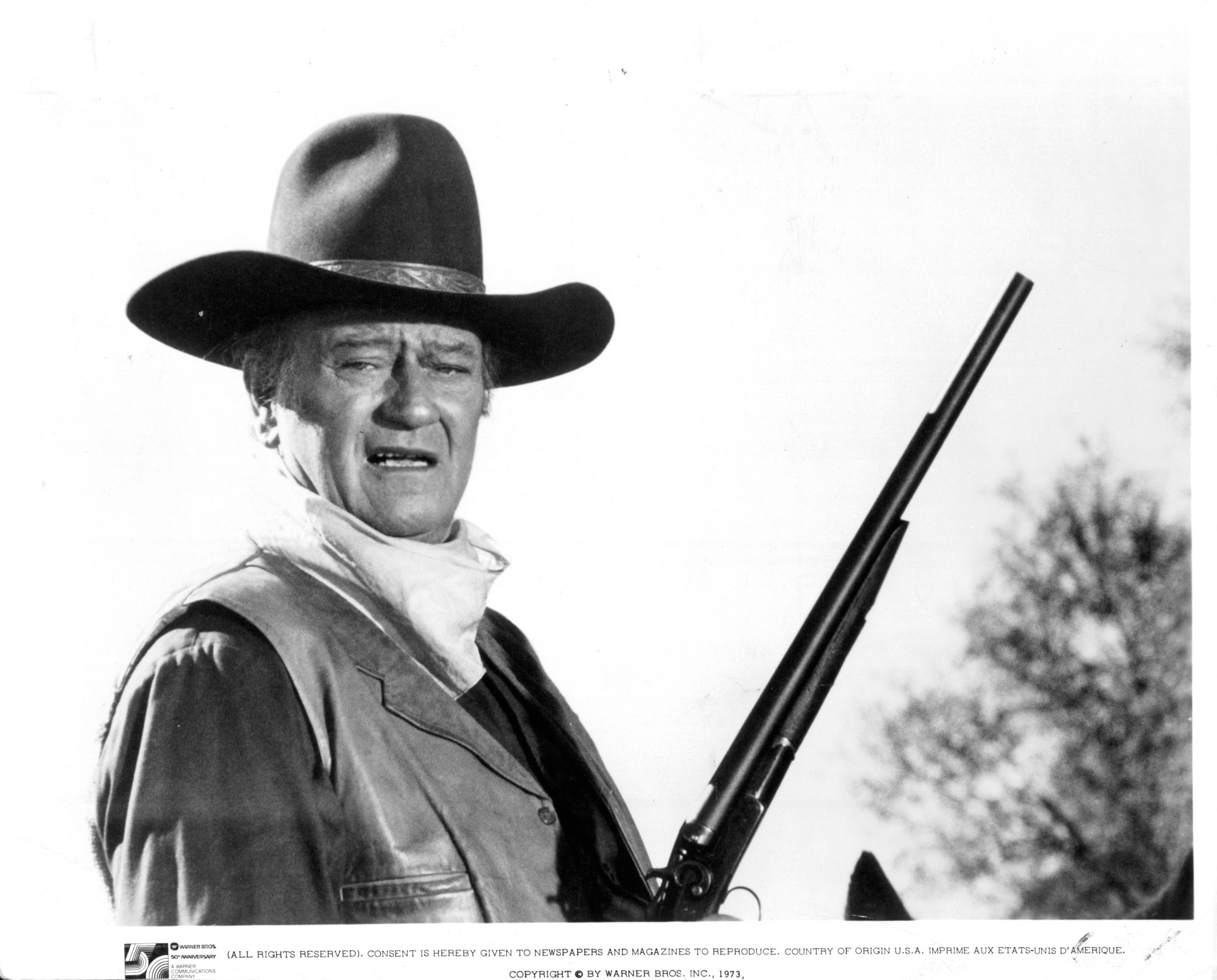'The Conqueror' actor John Wayne holding a gun