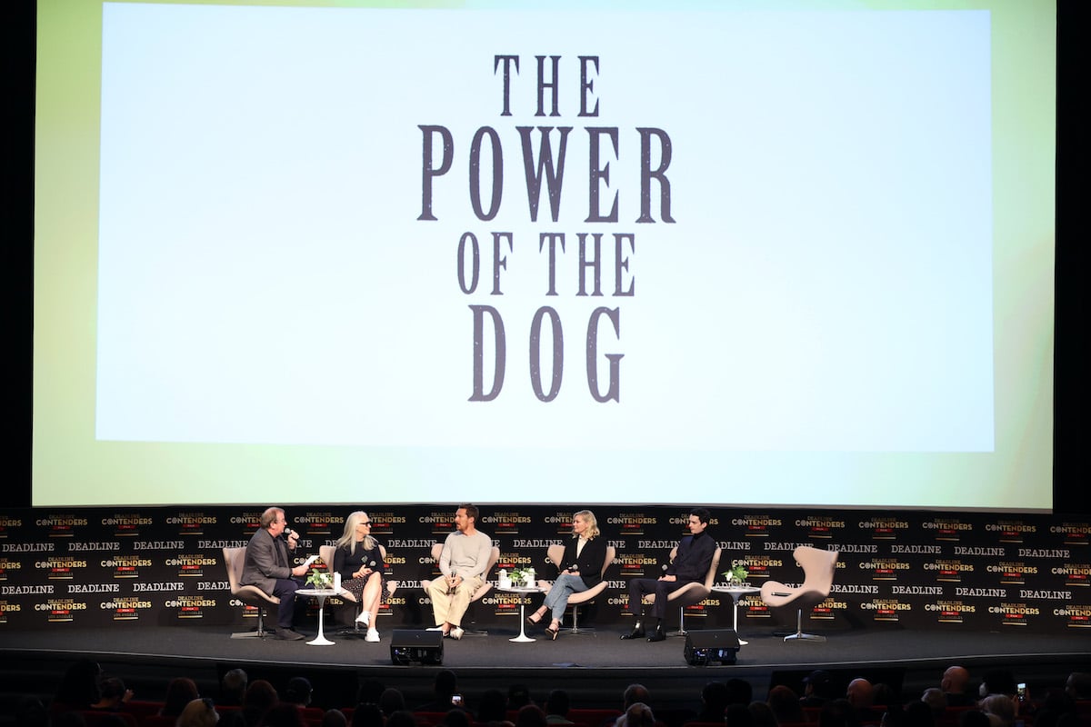 Pete Hammond, Jane Campion, Benedict Cumberbatch, Kirsten Dunst, and Kodi Smit McPhee sit in chairs on stage in front of 'The Power of the Dog' logo