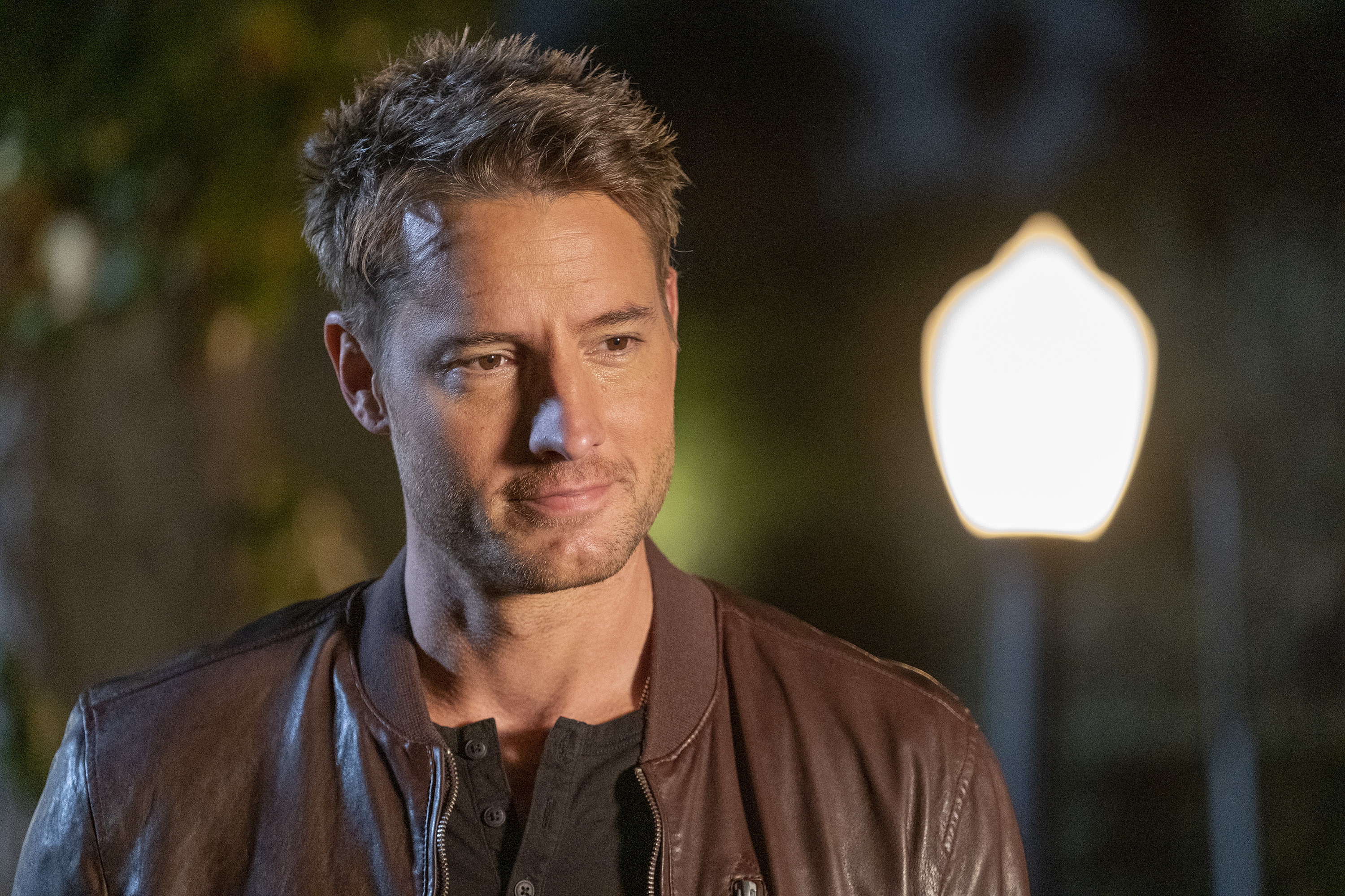 'This Is Us' star Justin Hartley, in character as Kevin Pearson, wears a brown leather jacket over a black shirt.