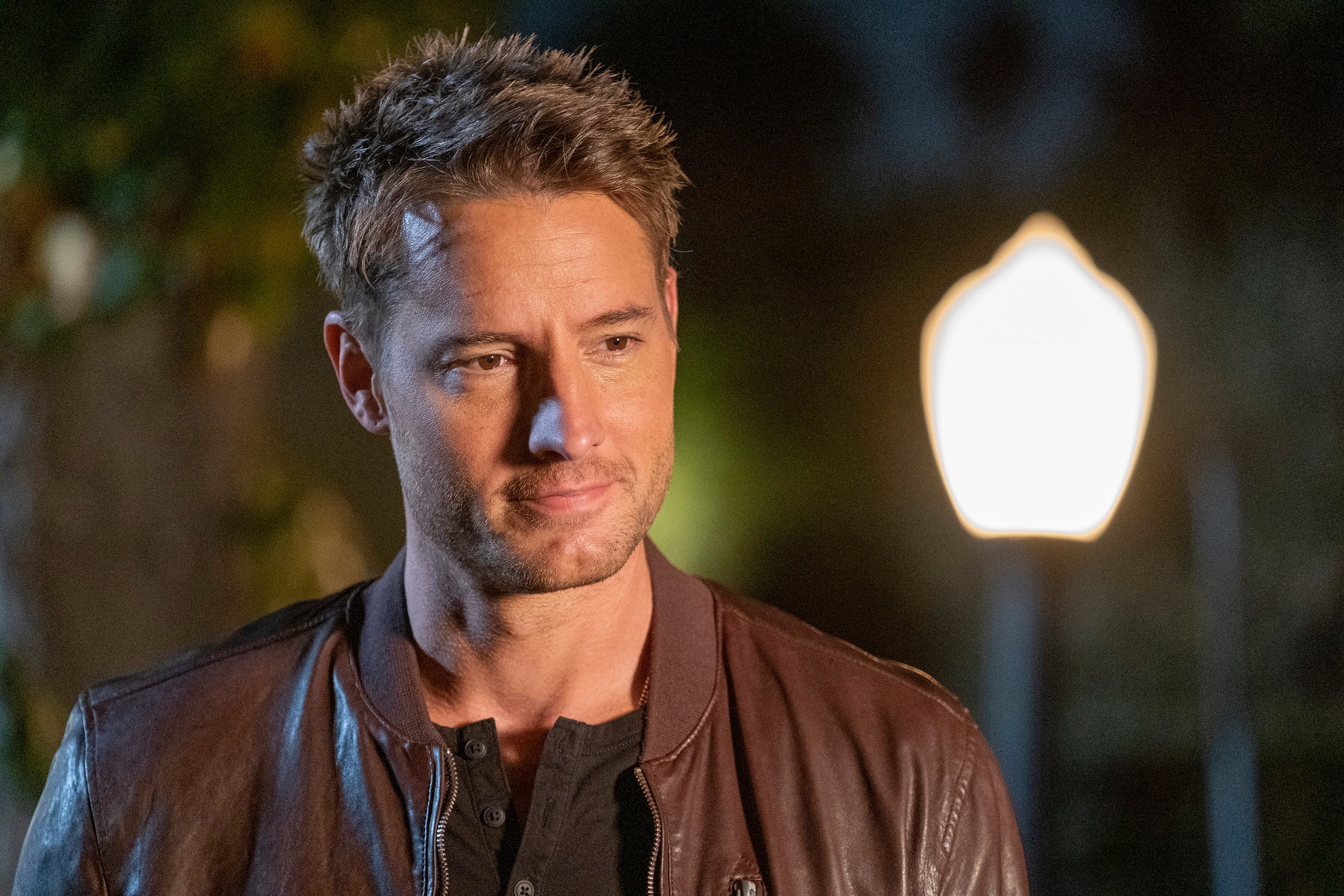 'This Is Us' star Justin Hartley, in character as Kevin Pearson, wears a brown leather jacket over a black shirt.