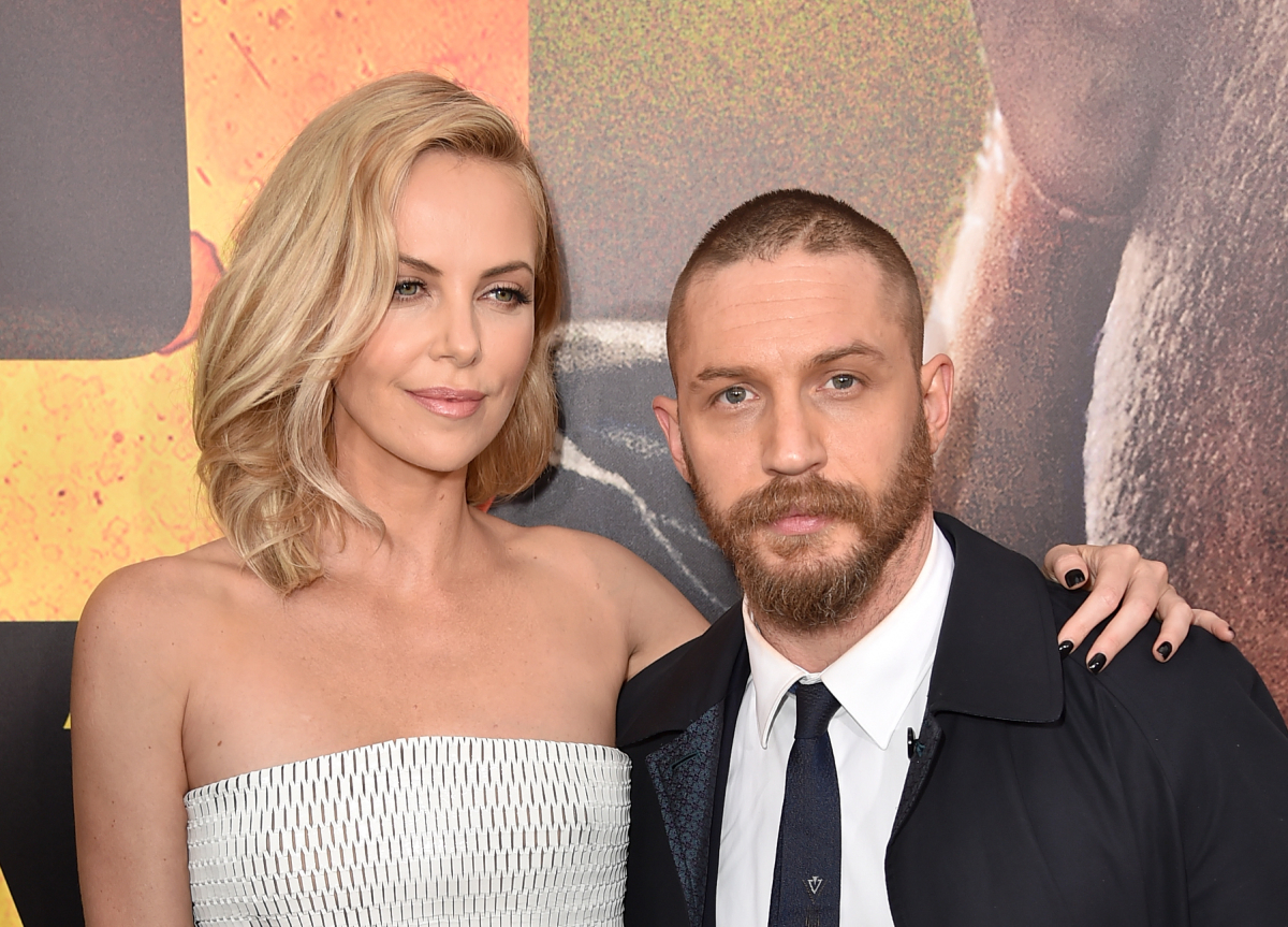 Charlize Theron in a strapless white gown and Tom Hardy in a tie and jacket attend the premiere of Warner Bros. Pictures' "Mad Max: Fury Road" at TCL Chinese Theatre on May 7, 2015