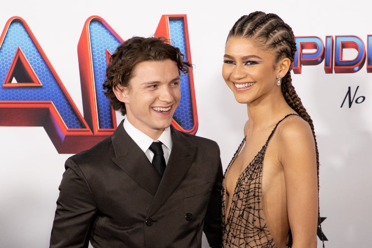 Tom Holland in a suit and tie and Zendaya in a spider-man inspired gown attend the Los Angeles premiere of Sony Pictures' 'Spider-Man: No Way Home' on December 13, 2021