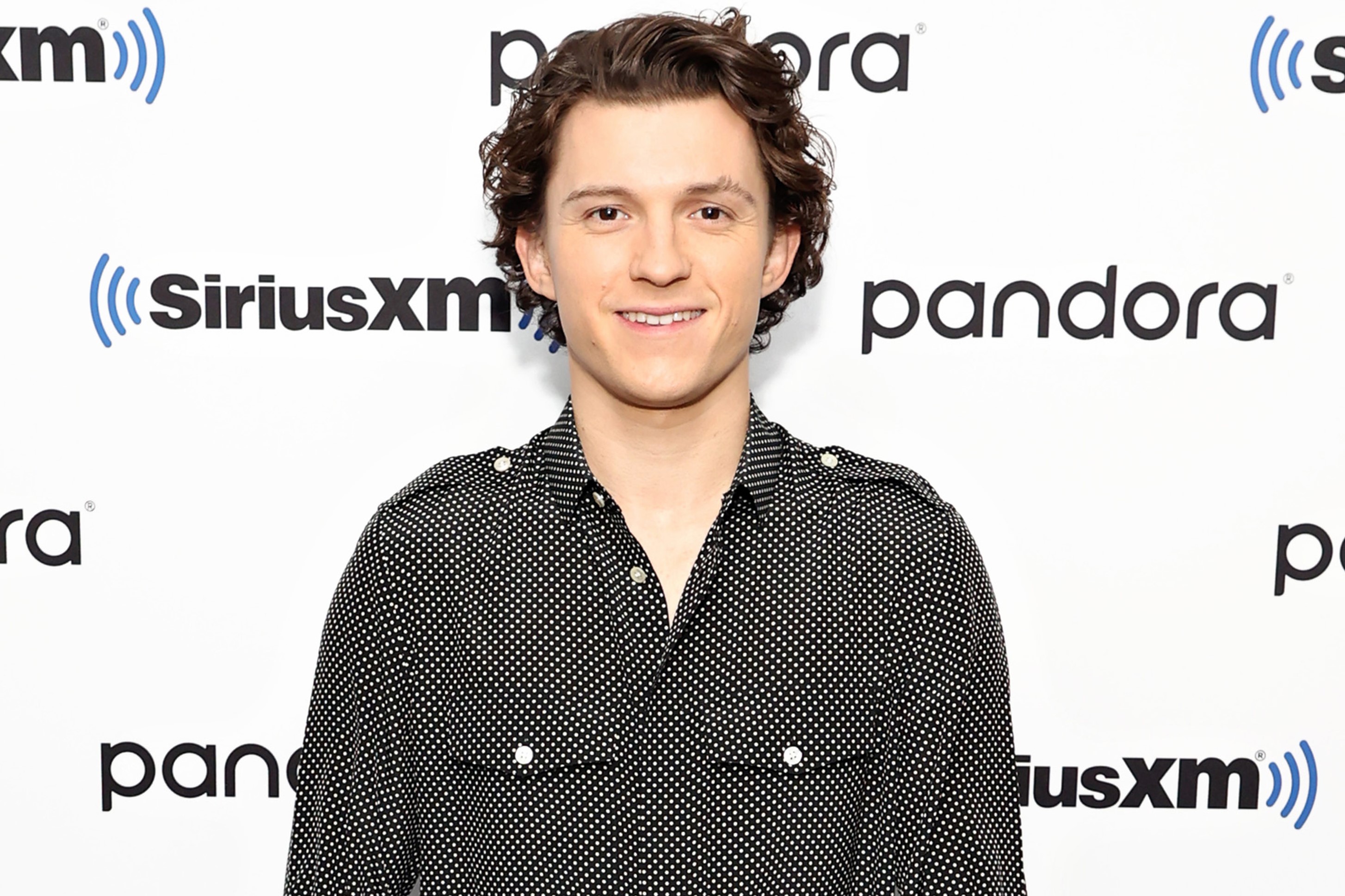 'Spider-Man: No Way Home' star Tom Holland wears a black button-up long-sleeved shirt with small white polka dots.