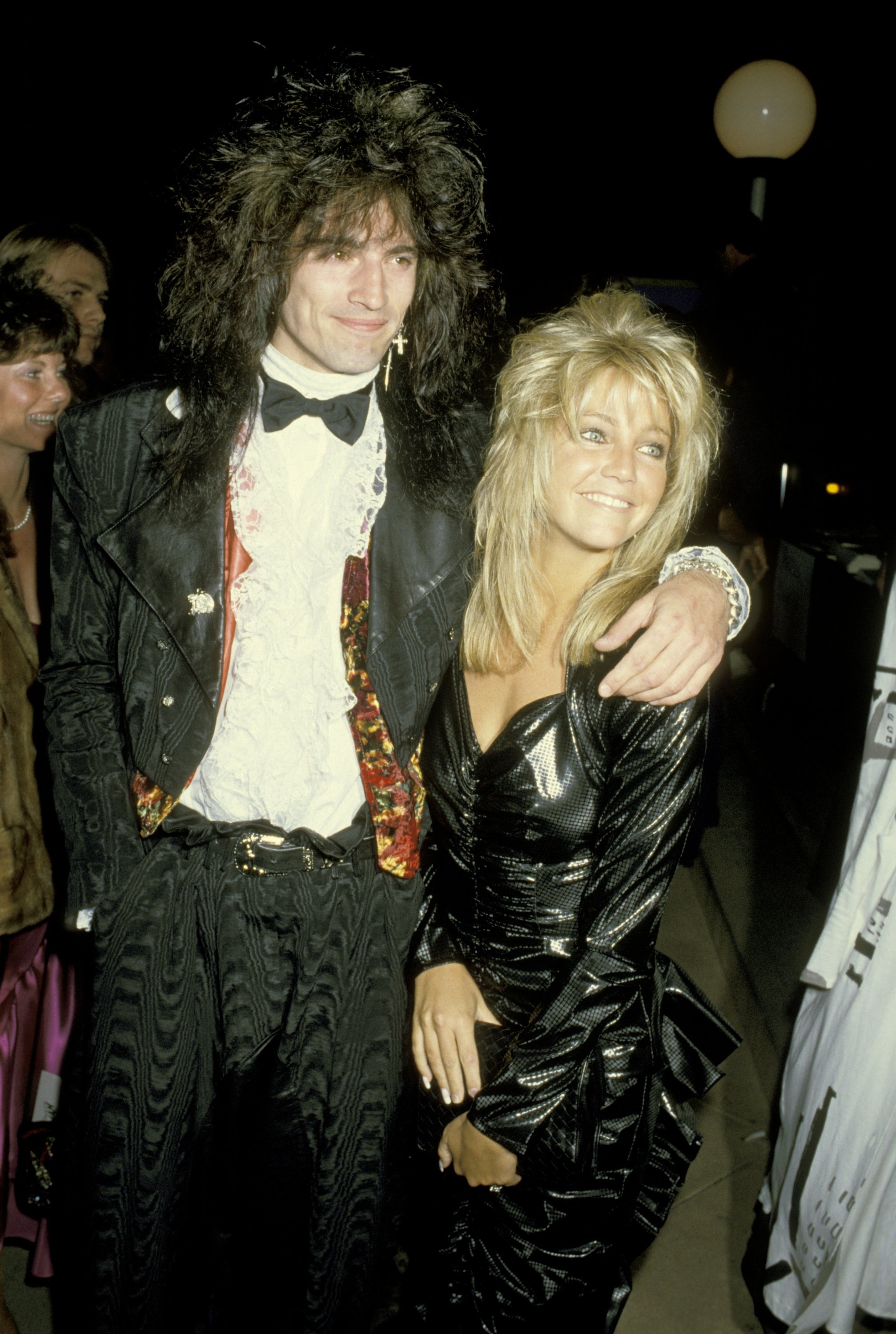 Tommy Lee posing with his arm around Heather Locklear at an event in 1986
