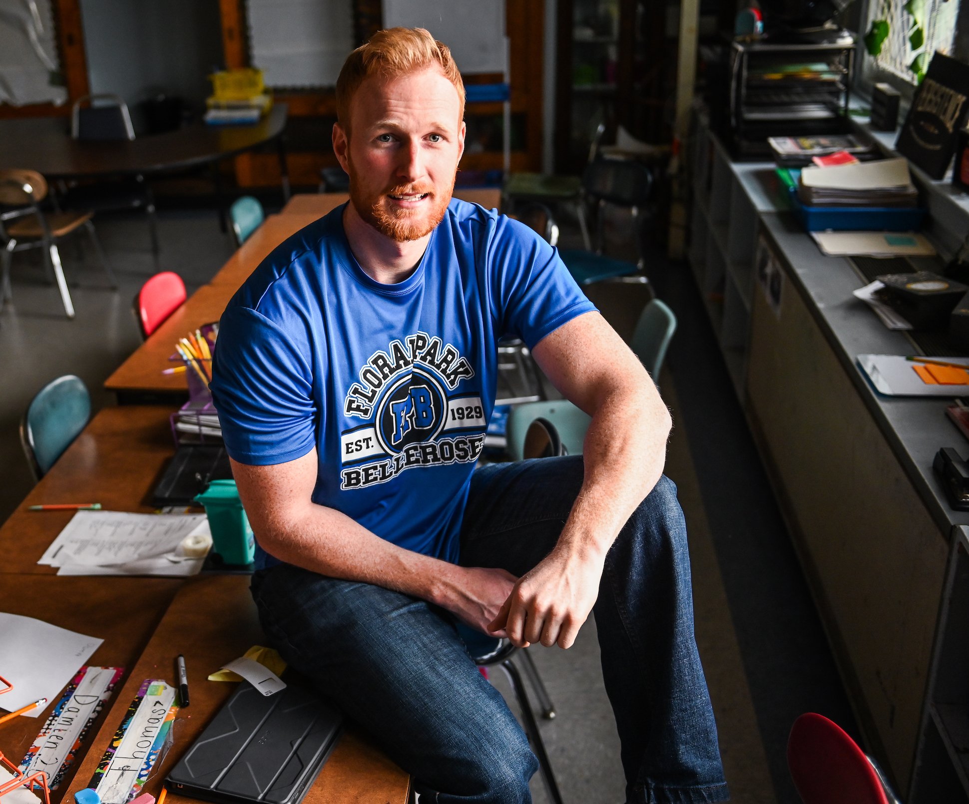 'Survivor' winner Tommy Sheehan sitting on a desk and smiling. Tommy Sheehan is rumored to not return to 'The Challenge' Season 38