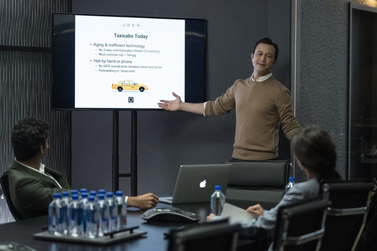 Travis Kalanick (Joseph Gordon-Levitt) presents Uber in a conference room in 'Super Pumped'