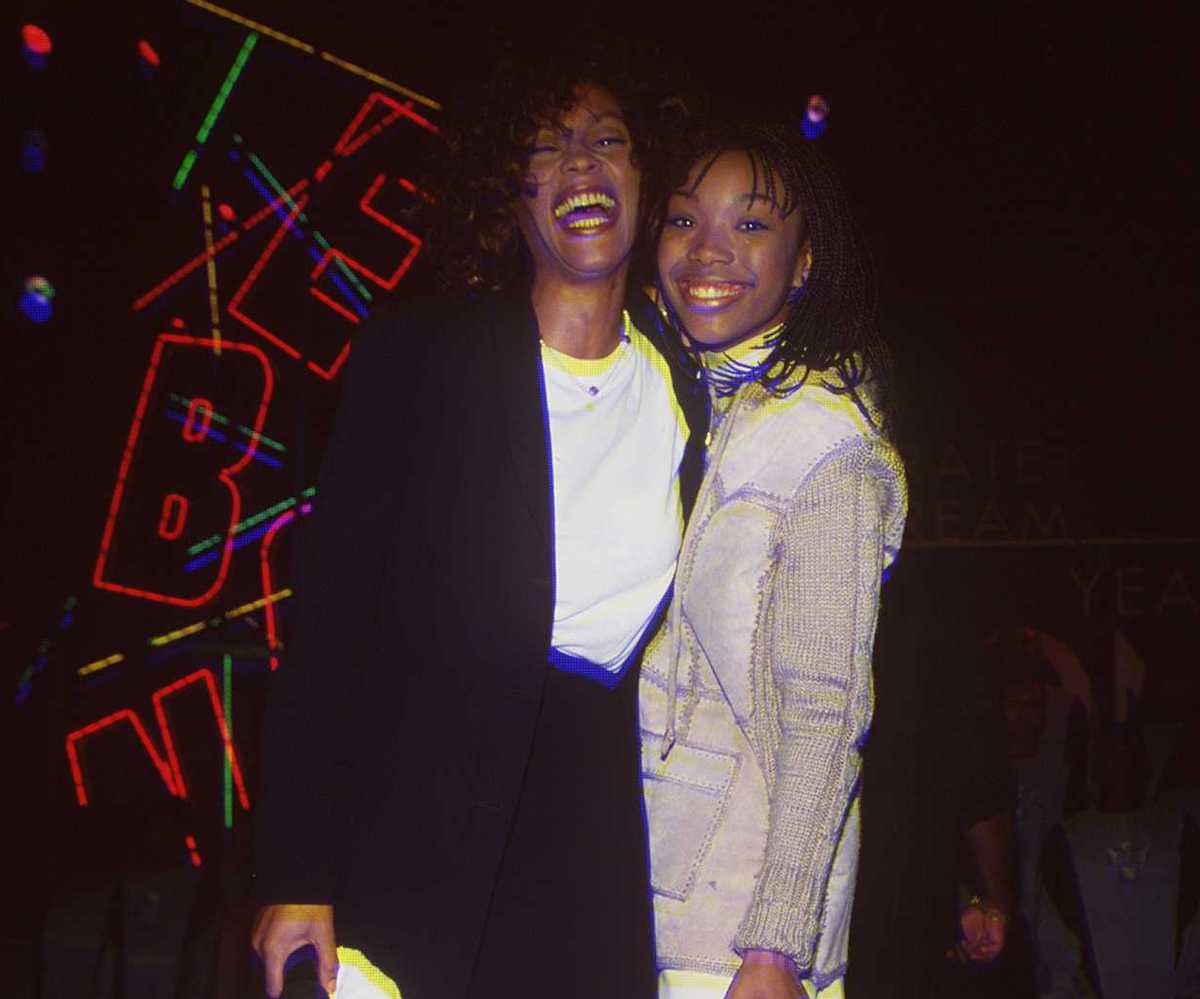 Whitney Houston and Brandy smile for a picture