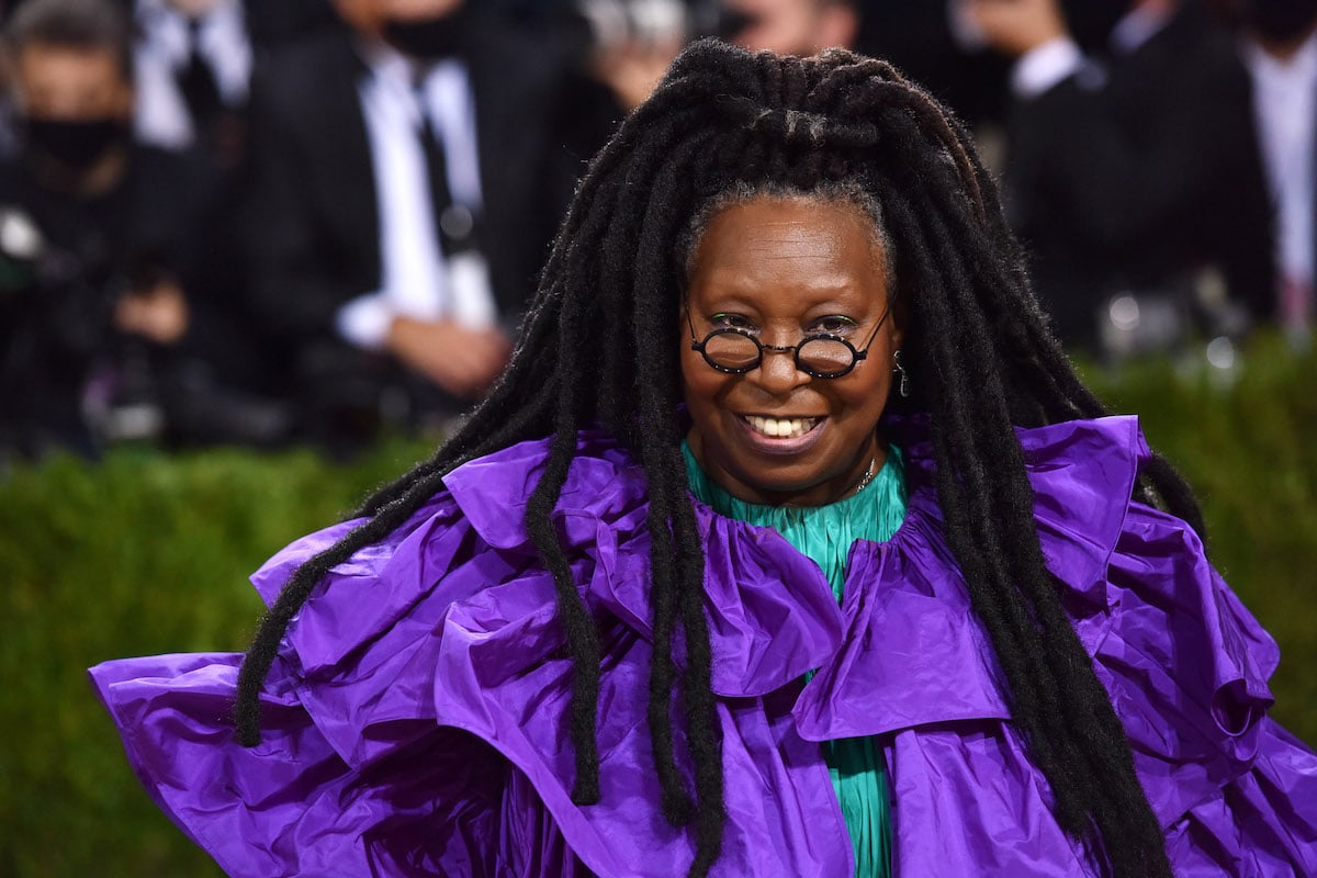 Whoopi Goldberg smiles at an event.