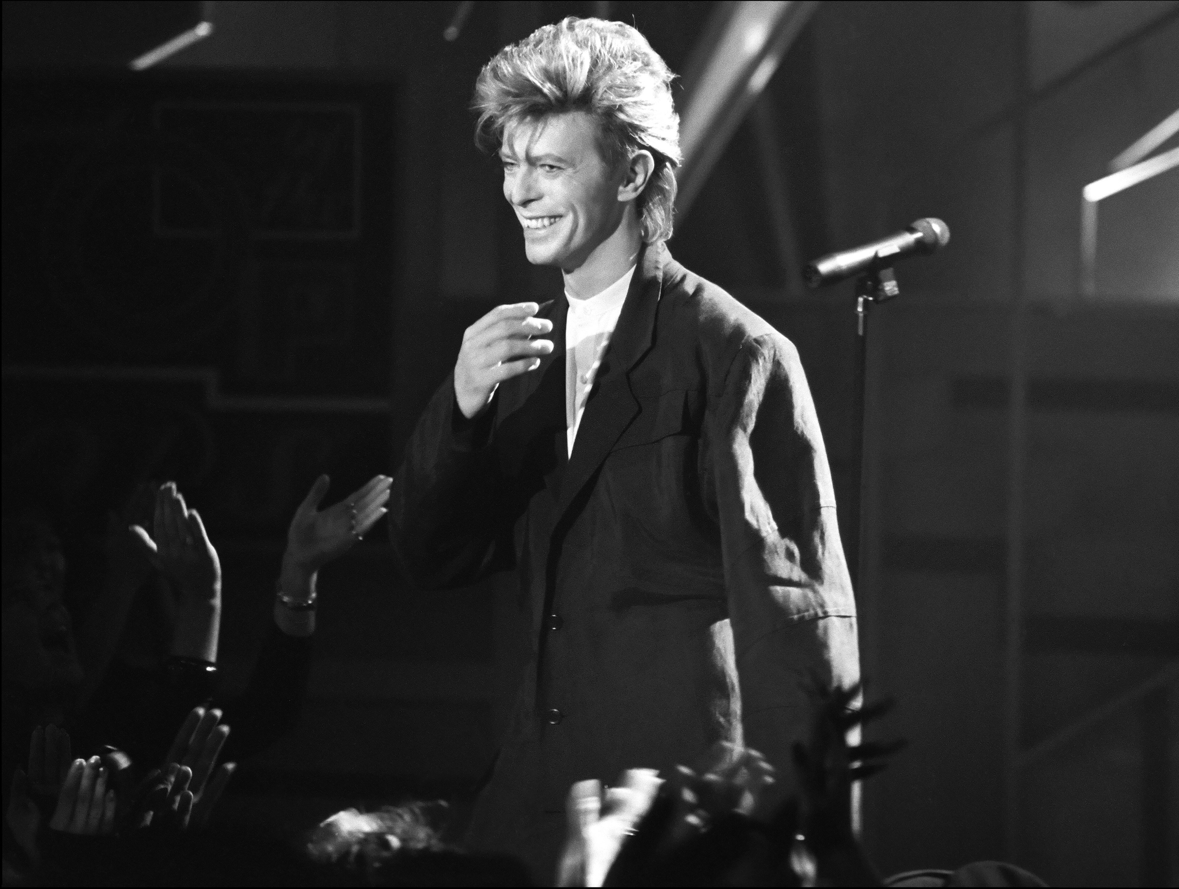 David Bowie standing near a microphone