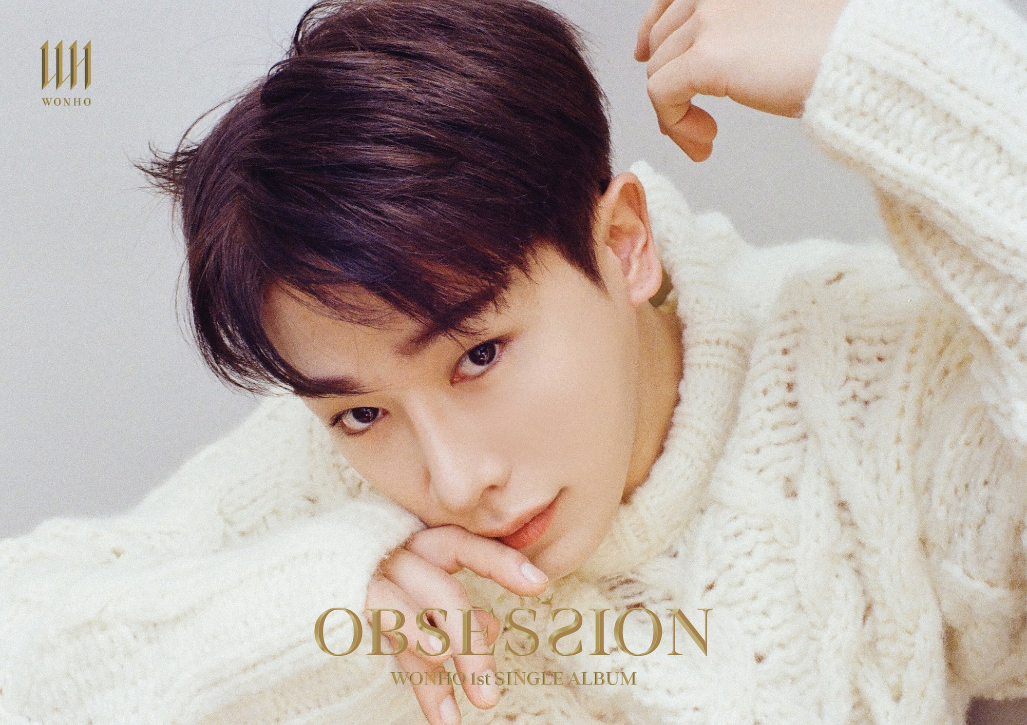 Wonho wears a white sweater in a promotional photo for 'Obsession'