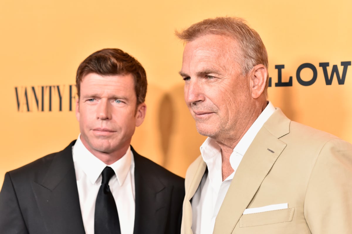 Taylor Sheridan in a black suit and tie and Kevin Costner wearing tan attend Yellowstone premiere at Paramount Pictures on June 11, 2018 in Los Angeles, California