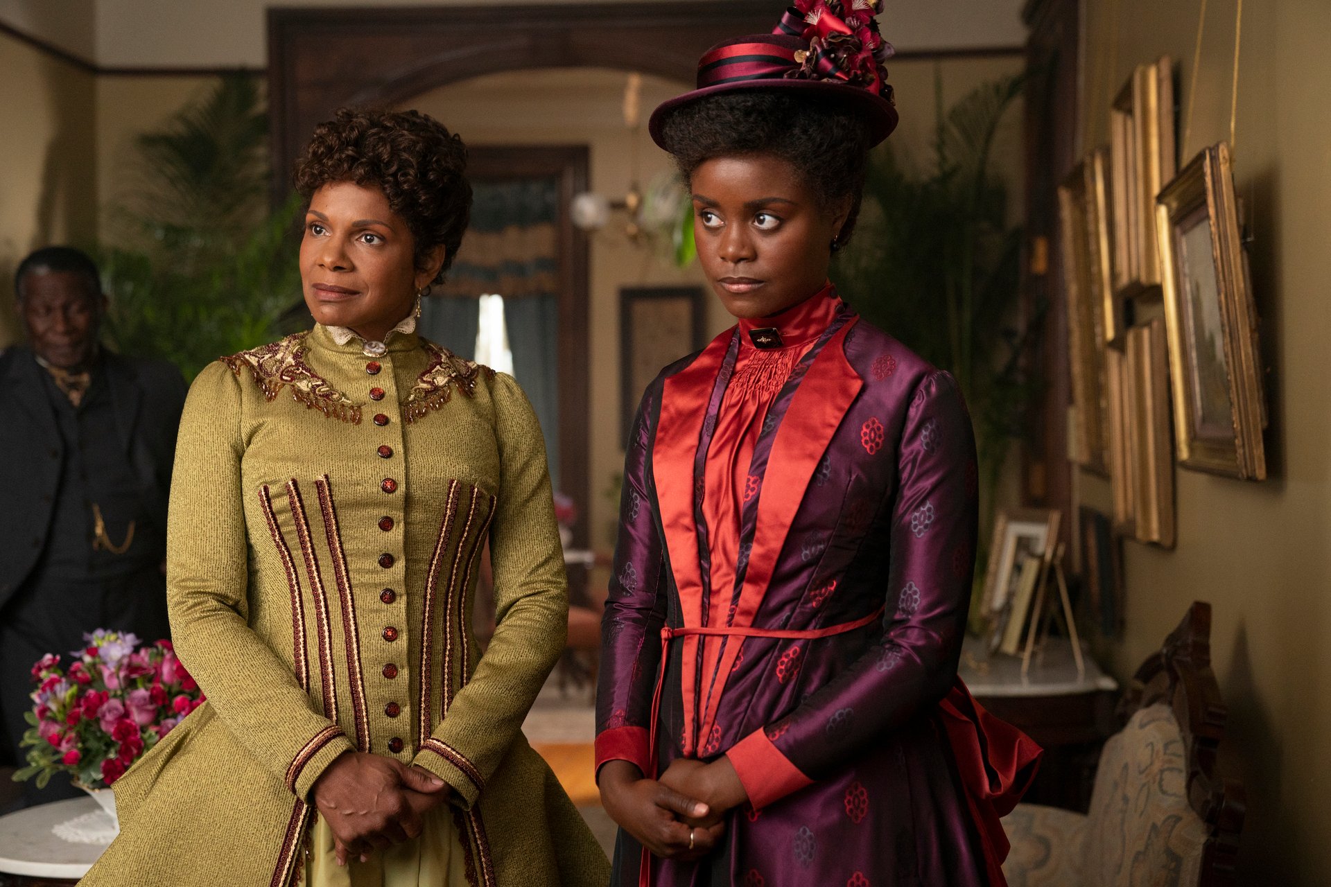 Audra McDonald, in an olive dress, and Denee Barton, in a purple dress and hat, in an episode of 'The Gilded Age'