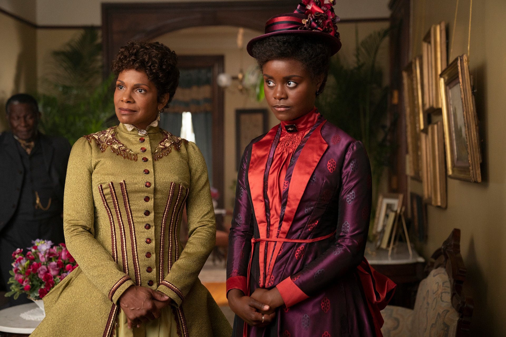Audra McDonald, in an olive dress, and Denee Barton, in a purple dress and hat, in an episode of 'The Gilded Age' 