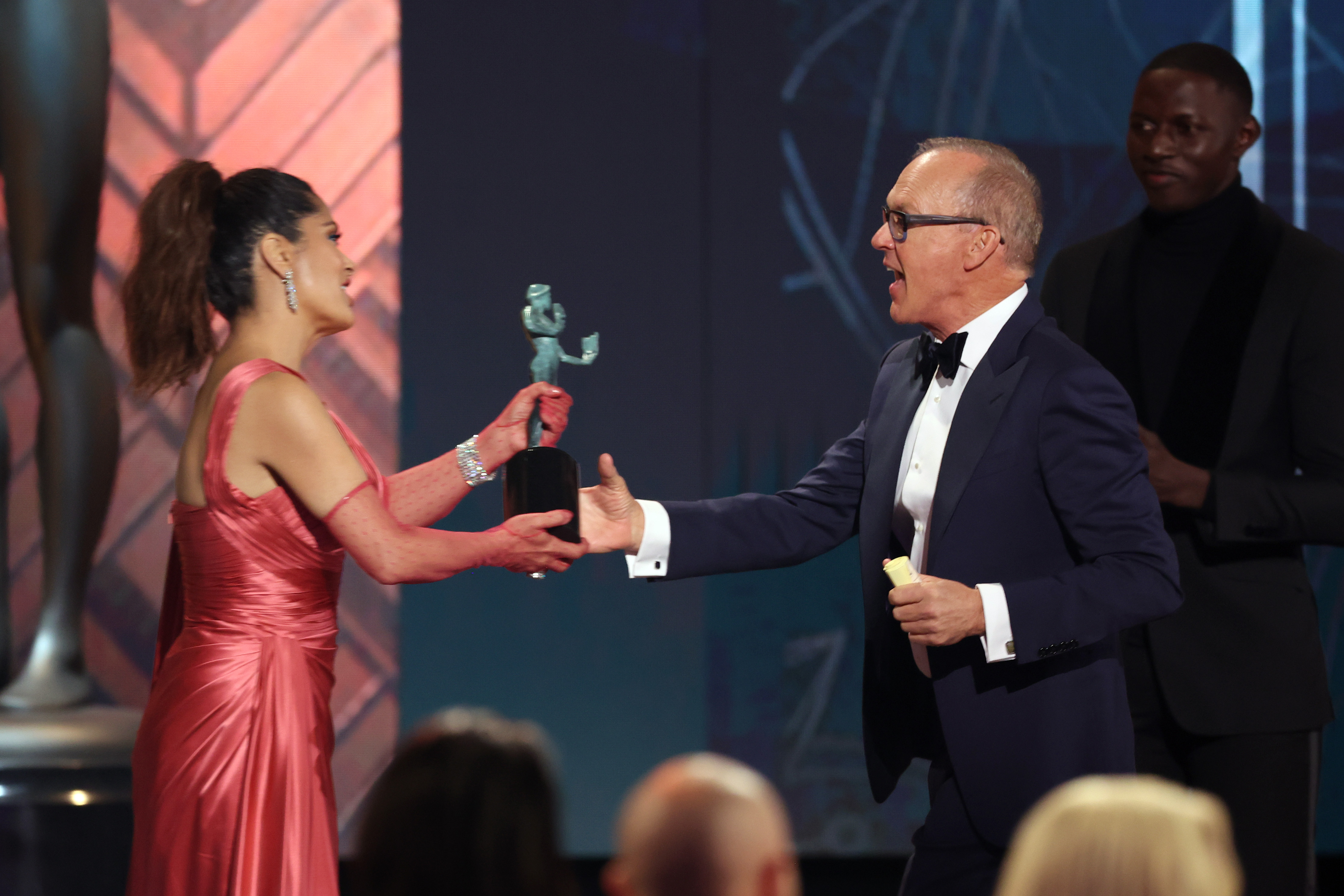 Salma Hayek wearing a red dress and handing out an award to Michael Keaton at the SAG Awards 2022