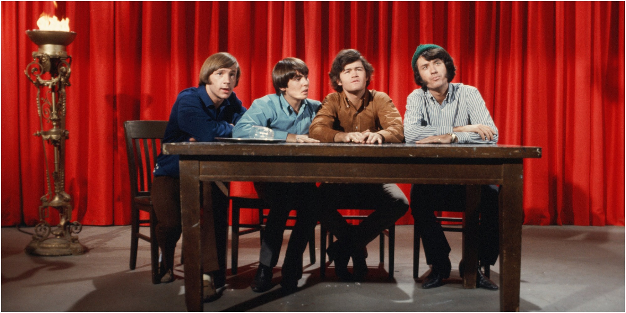 The Monkkes pose in front of a red curtain in the episode "The Devil and Peter Tork."