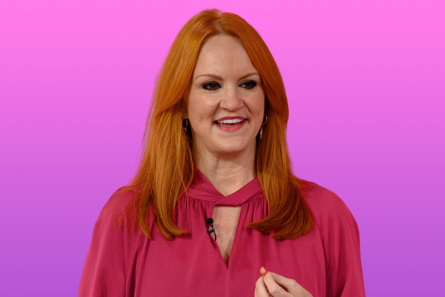 Ree Drummond with red hair, smiling during an interview, and wearing a magenta top