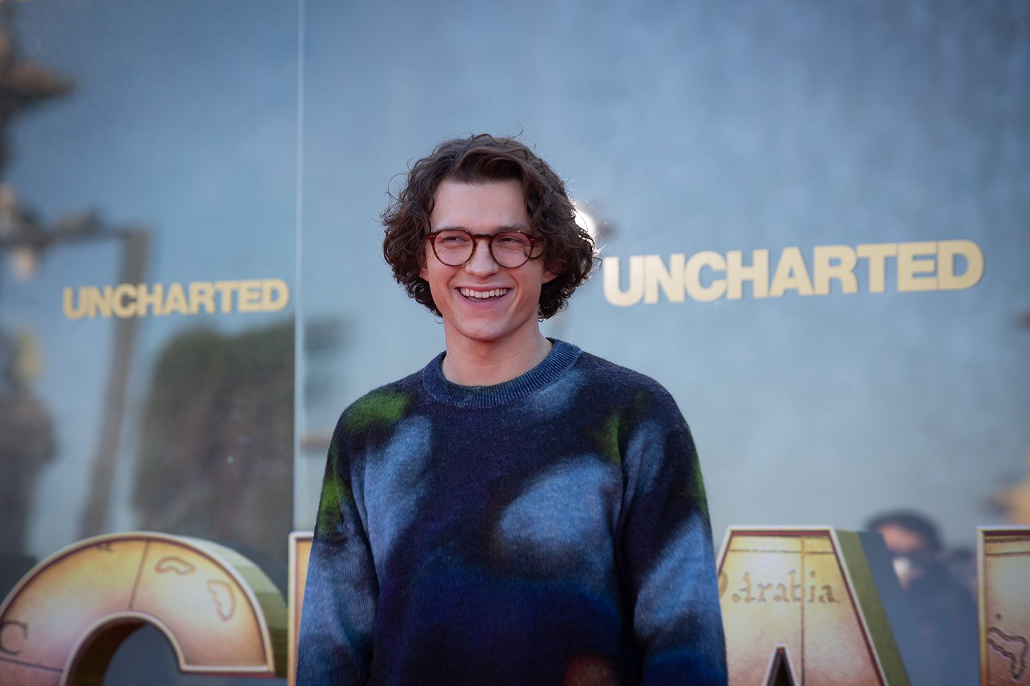 Tom Holland attends a press event for his new video game movie, Uncharted