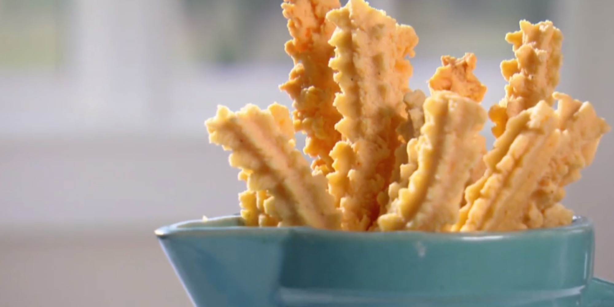 Trisha Yearwood makes savory cheese straws in a Food Network video.