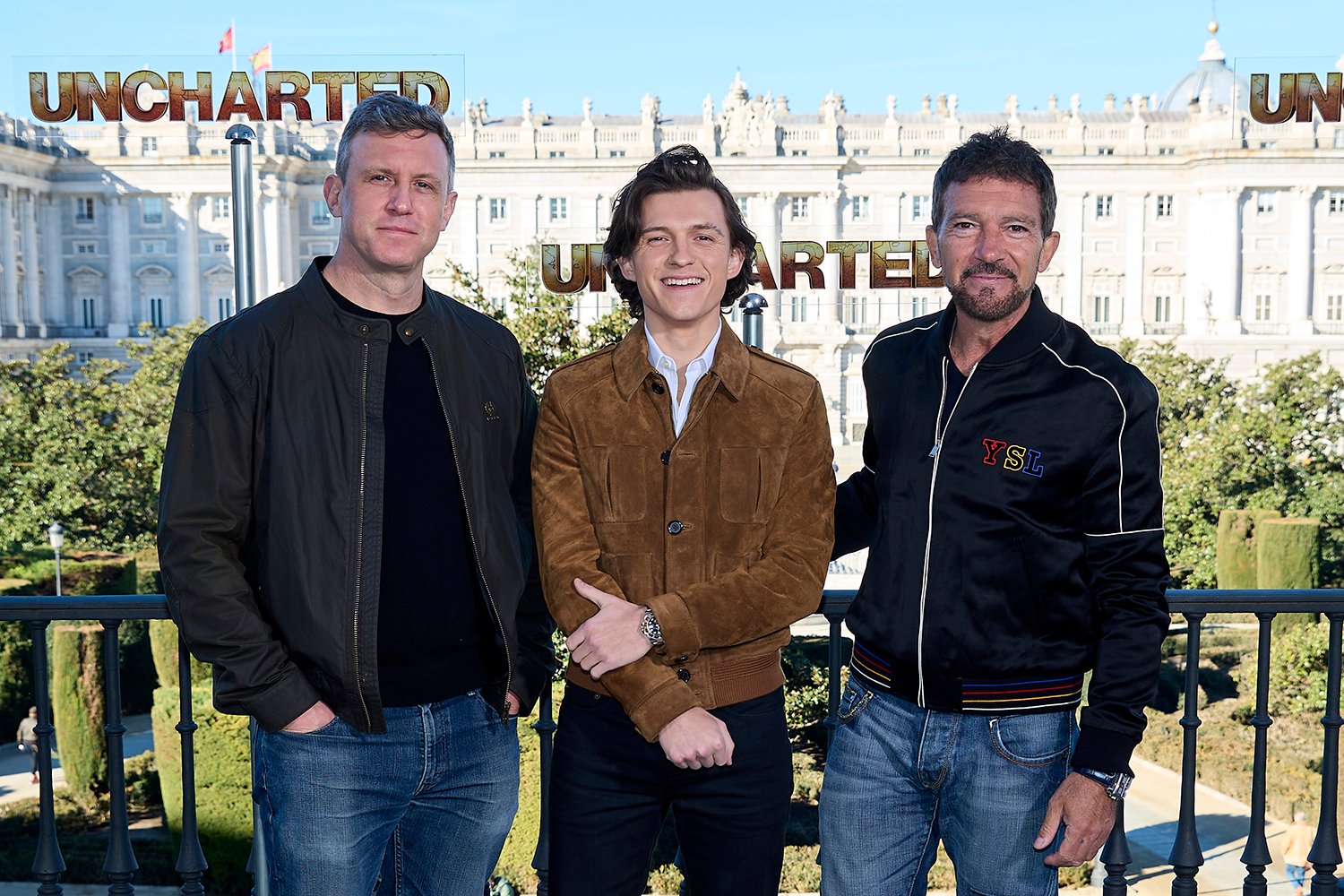 Uncharted director Ruben Fleischer poses with with stars Tom Holland and Antonio Banderas amid sequel and movie franchise discussions