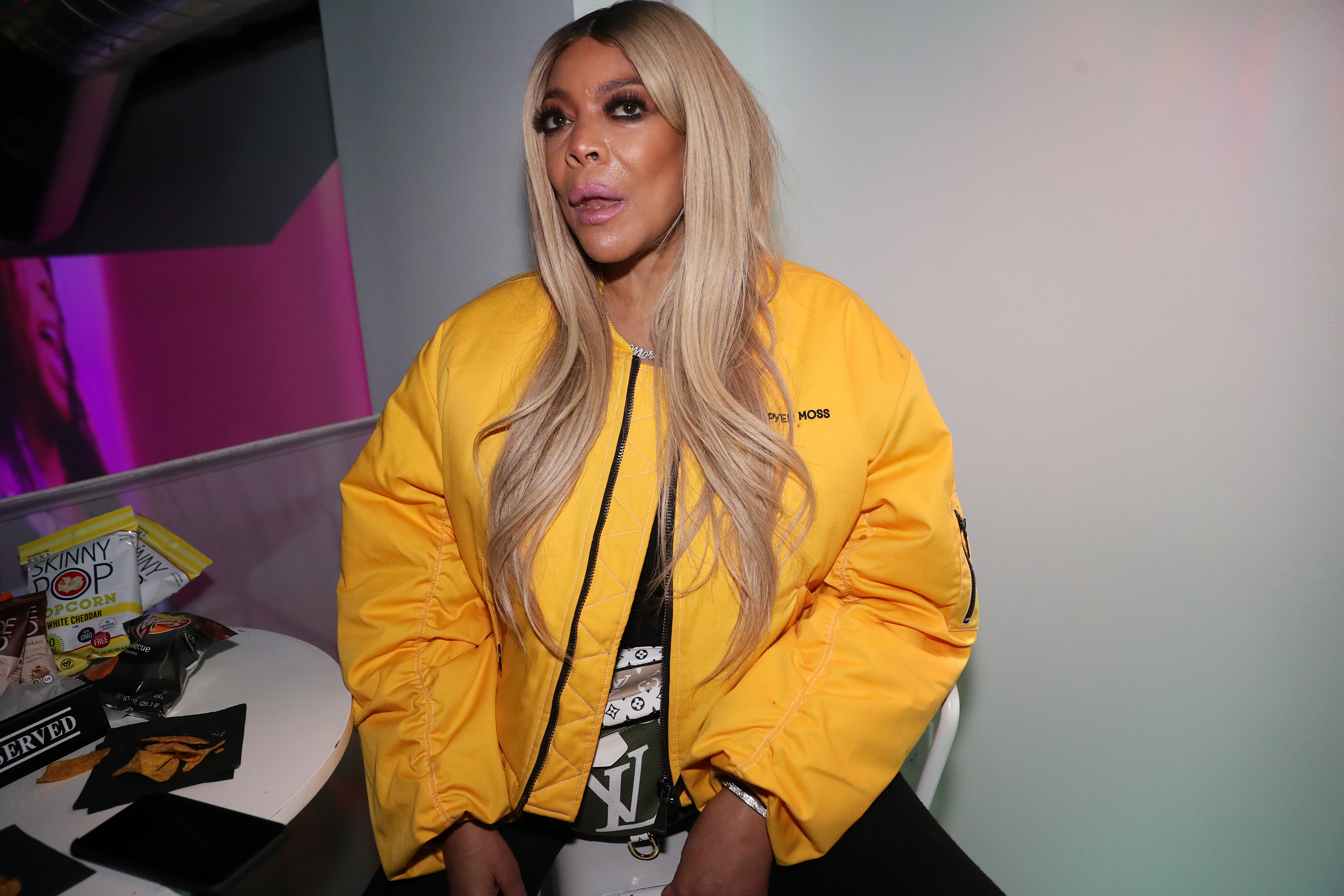 Wendy Williams in long straight blonde hair, wearing a yellow jacket