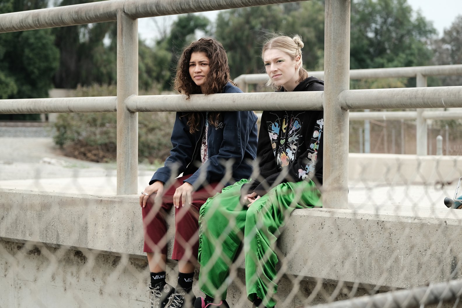 Rue (Zendaya) and Jules (Hunter Schafer) sitting on an overpass in an episode of the HBO series 'Euphoria'