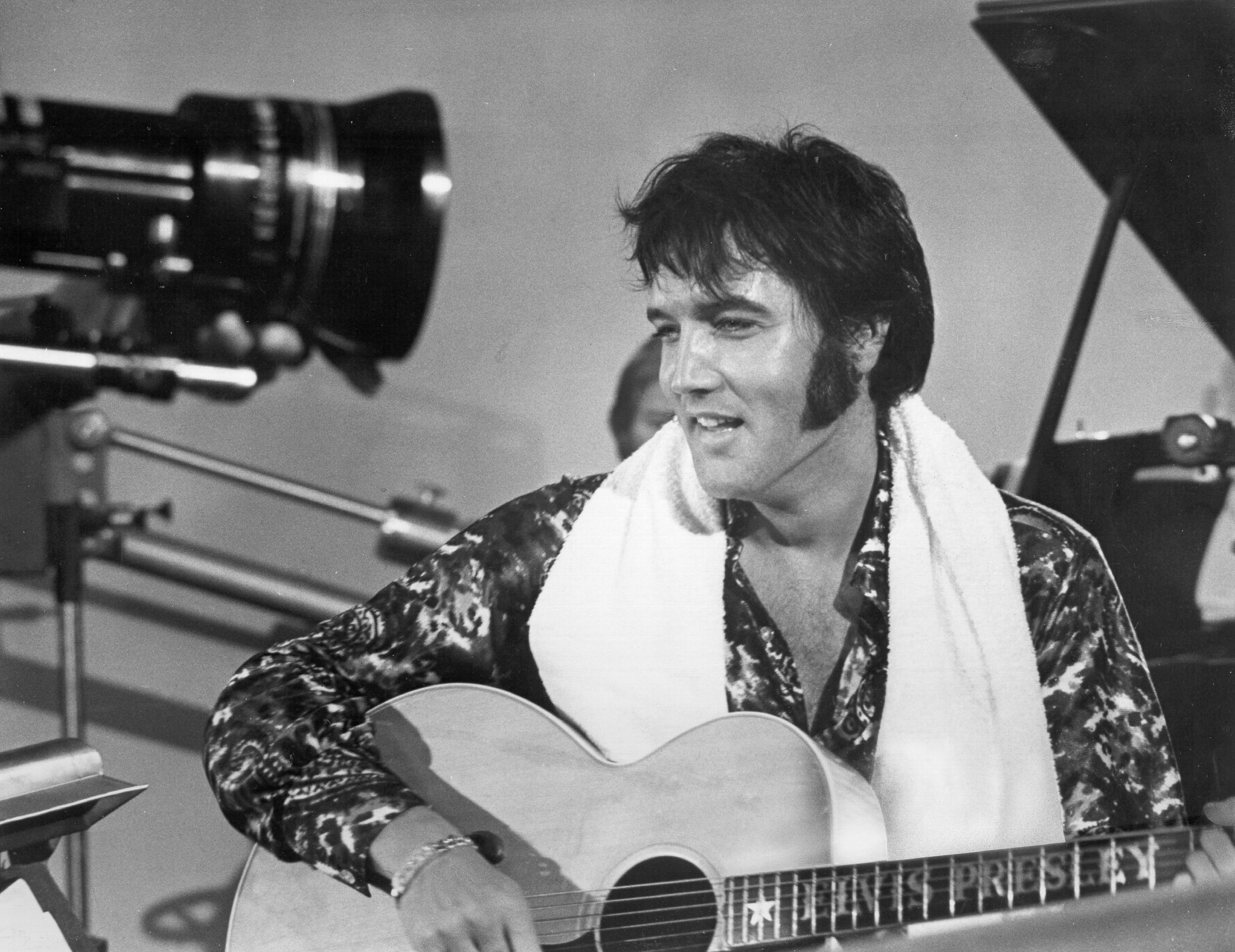 Elvis Presley holding a guitar