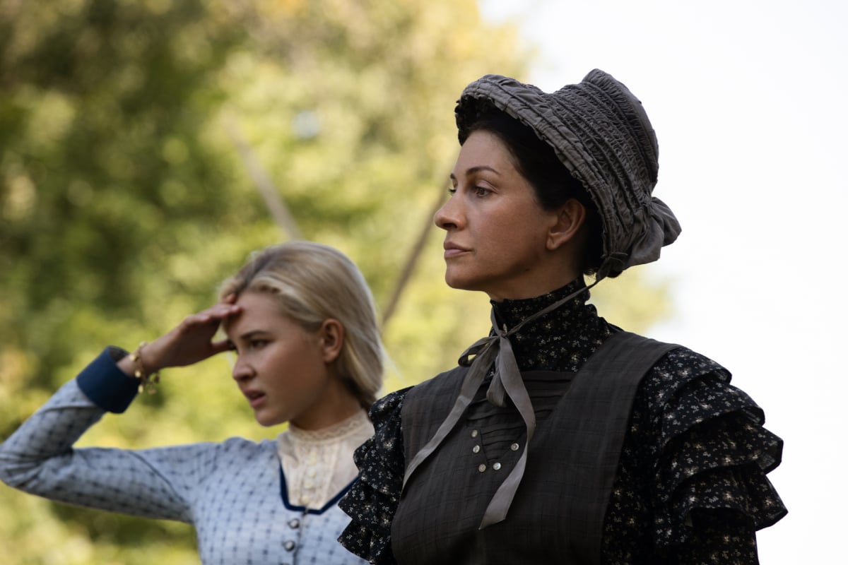 Isabel May as Elsa and Dawn Olivieri as Claire in 1883. Elsa shields her eyes from the sun.