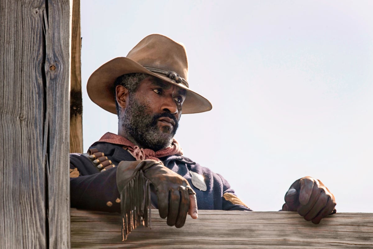 LaMonica Garrett as Thomas in 1883. Thomas wears his Civil War uniform and a cowboy hat.