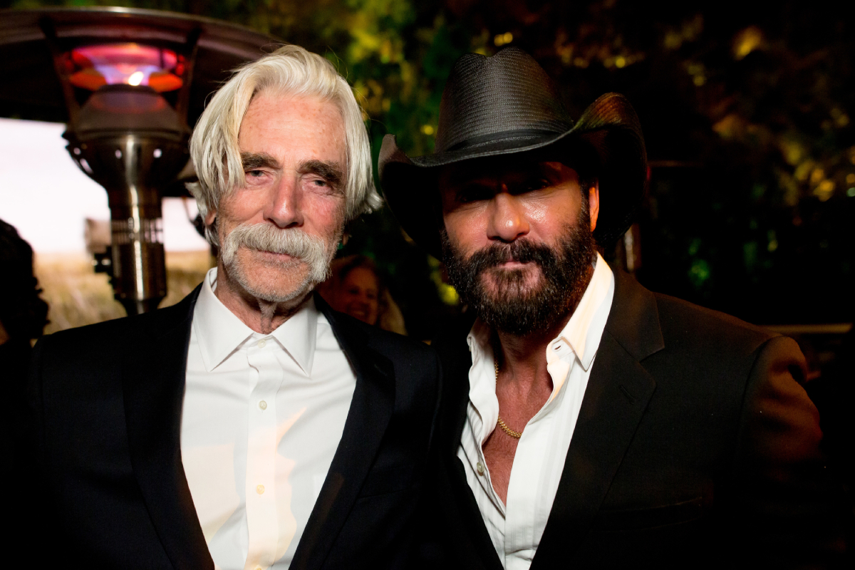 1883 stars Sam Elliott and Tim McGraw pose together wearing formal attire, and McGraw wears a cowboy hat. Tim McGraw and Faith Hill star with Sam Elliott in 1883, the Yellowstone prequel.