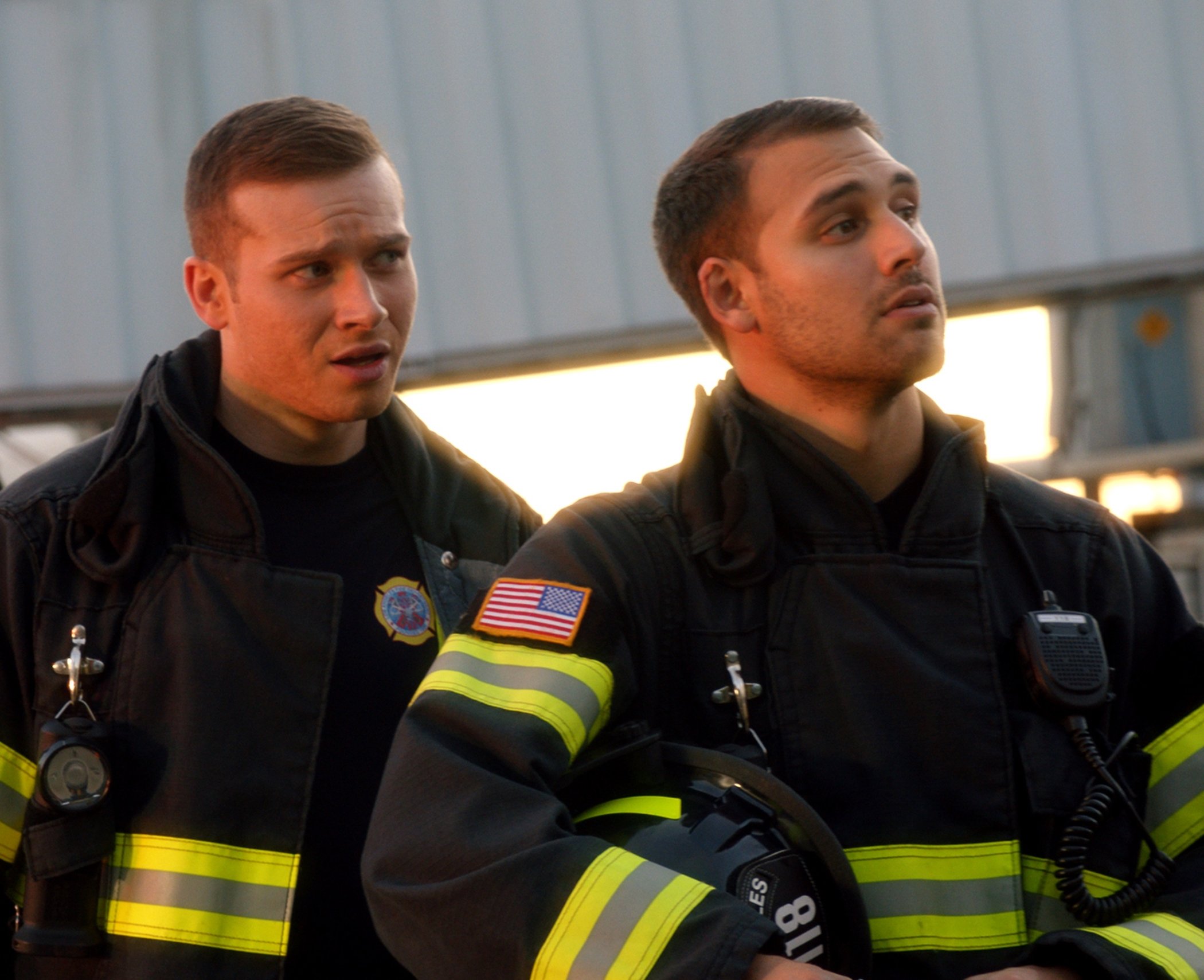 Buck and Eddie Diaz, characters in '9-1-1' Season 5, standing next to each other in firefighting gear