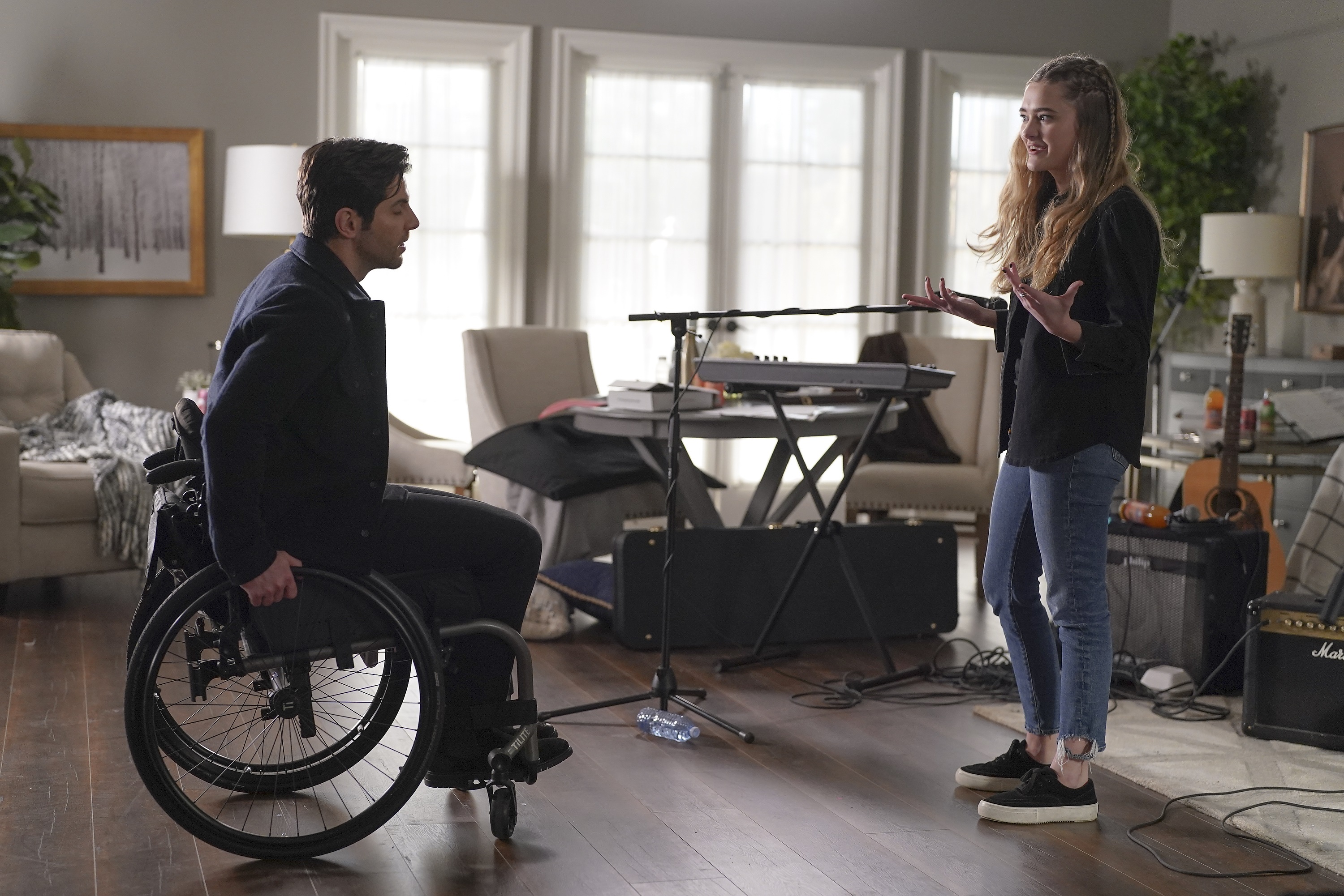 'A Million Little Things' cast members David Giuntoli and Lizzy Greene yelling at each other as Eddie and Sophie