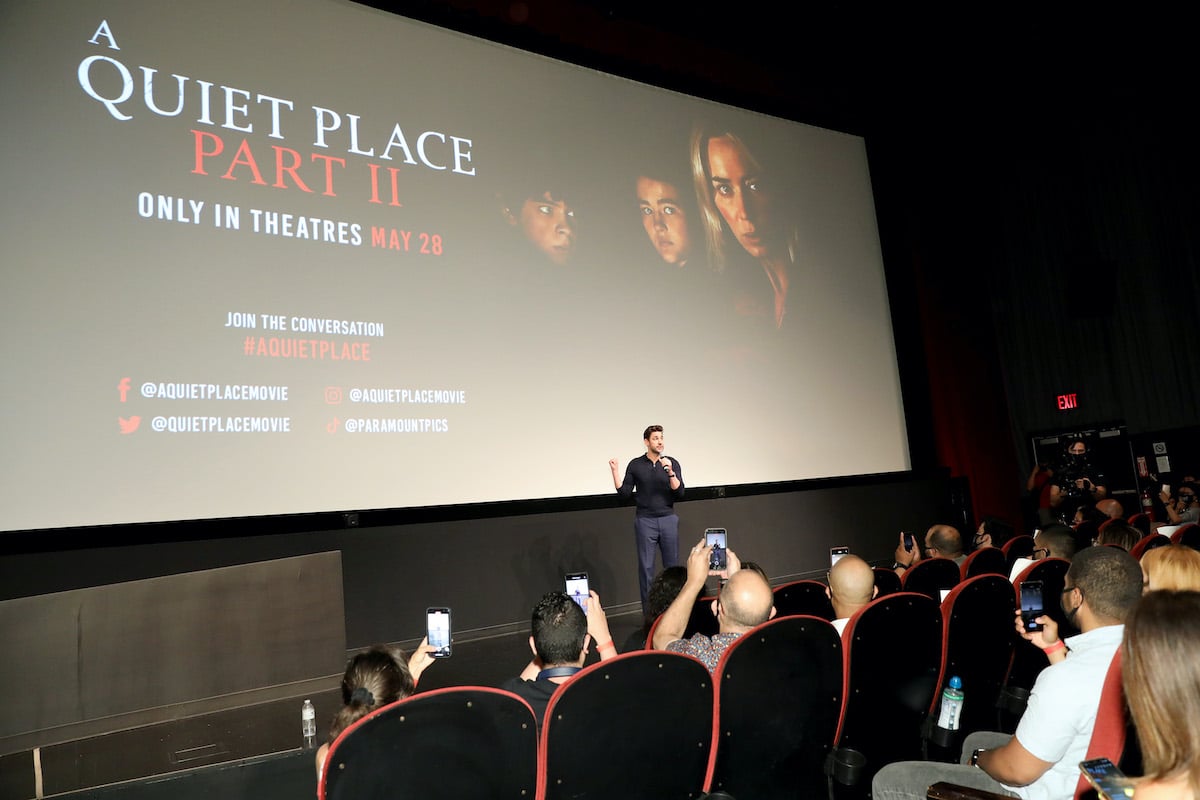 John Krasinski speaks in front of the poster for ‘A Quiet Place Part II'