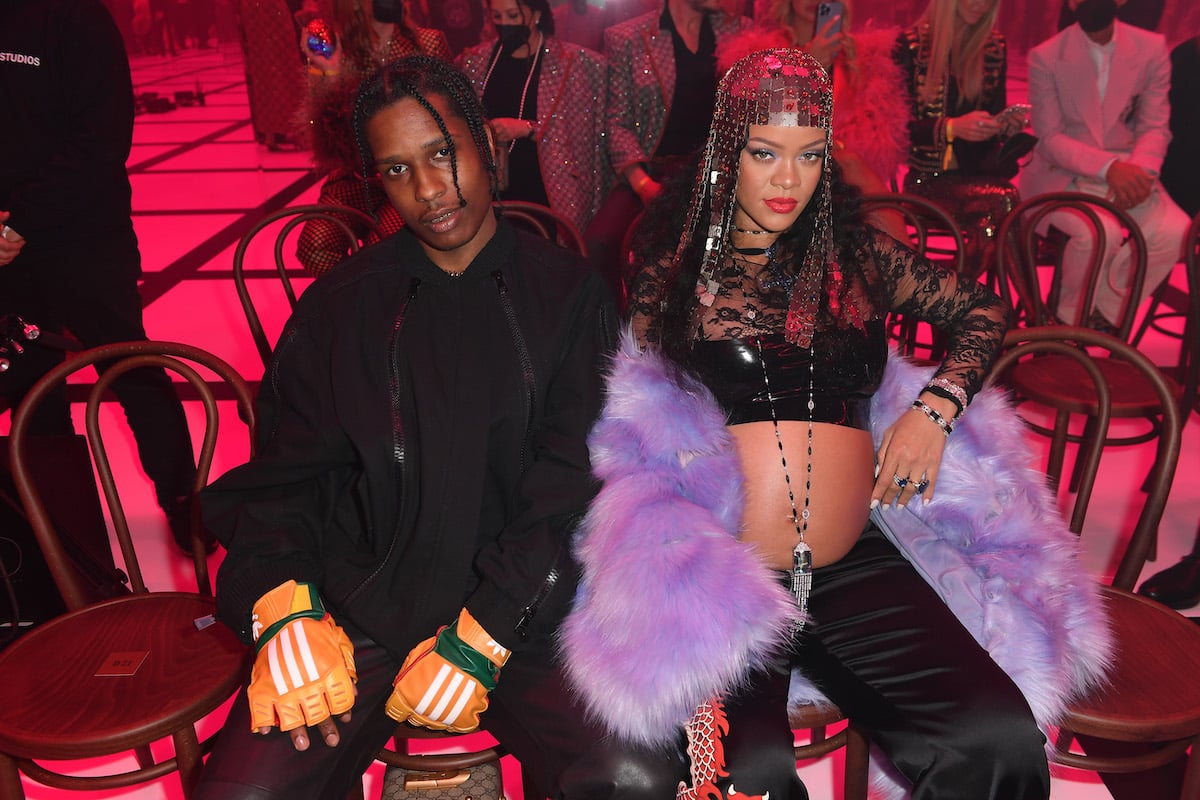 A$AP Rocky and Rihanna sit together at an event.