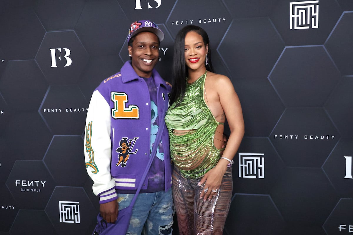 A$AP Rocky and Rihanna smile and pose together at an event.