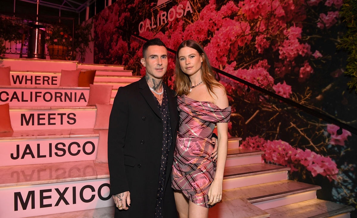 Adam Levine and Behati Prinsloo, who are selling their Pacific Palisades mansion, pose together for a photo at CALIROSA Tequila’s launch party