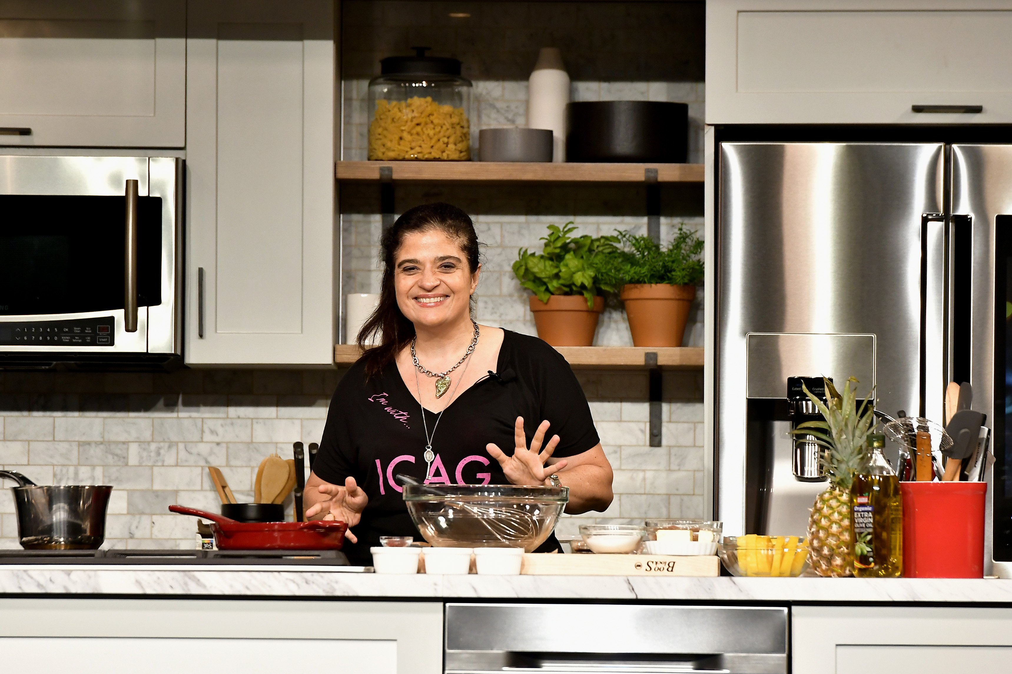 Food Network star Alex Guarnaschelli wears a black T-shirt in this photograph.