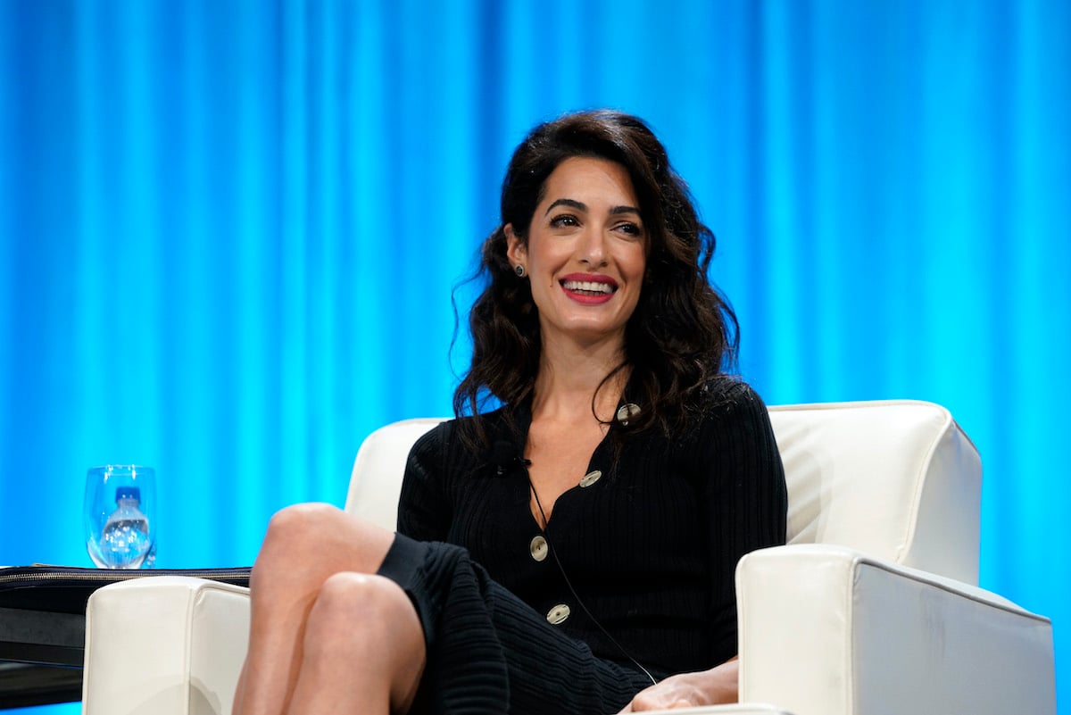 Amal Clooney smiling, seated
