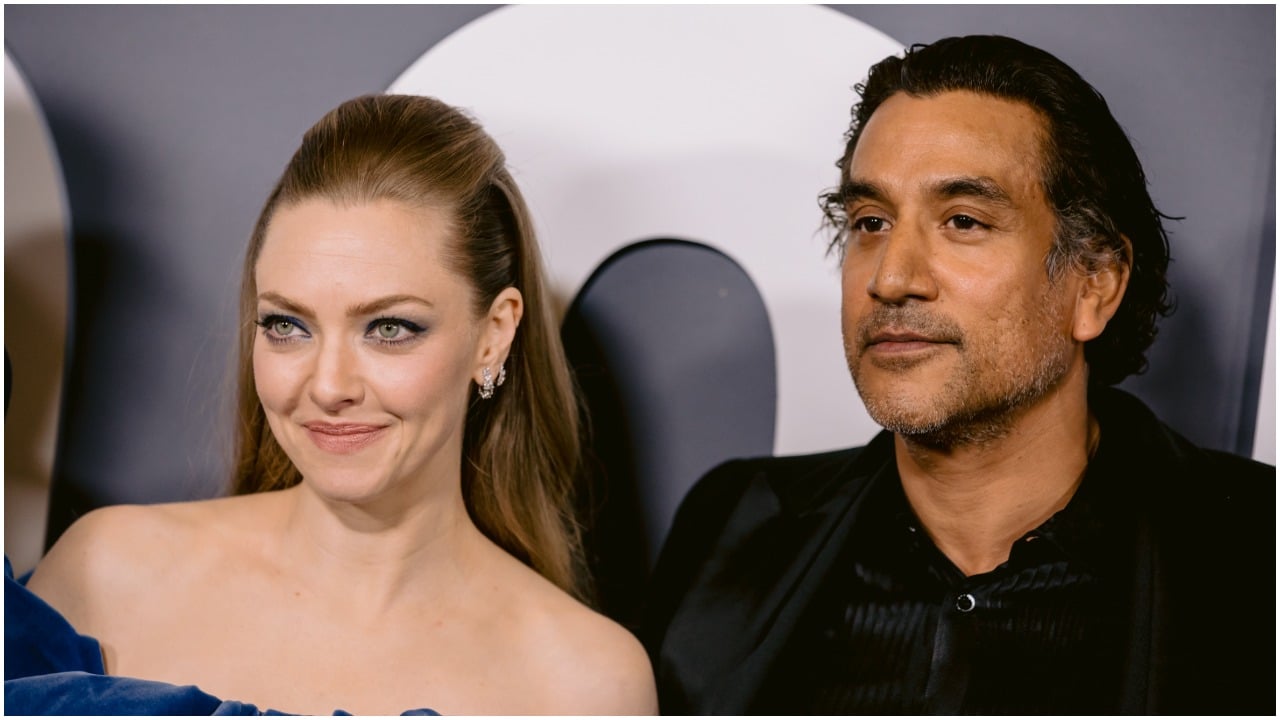 Amanda Seyfried and Naveen Andrews standing together and smiling