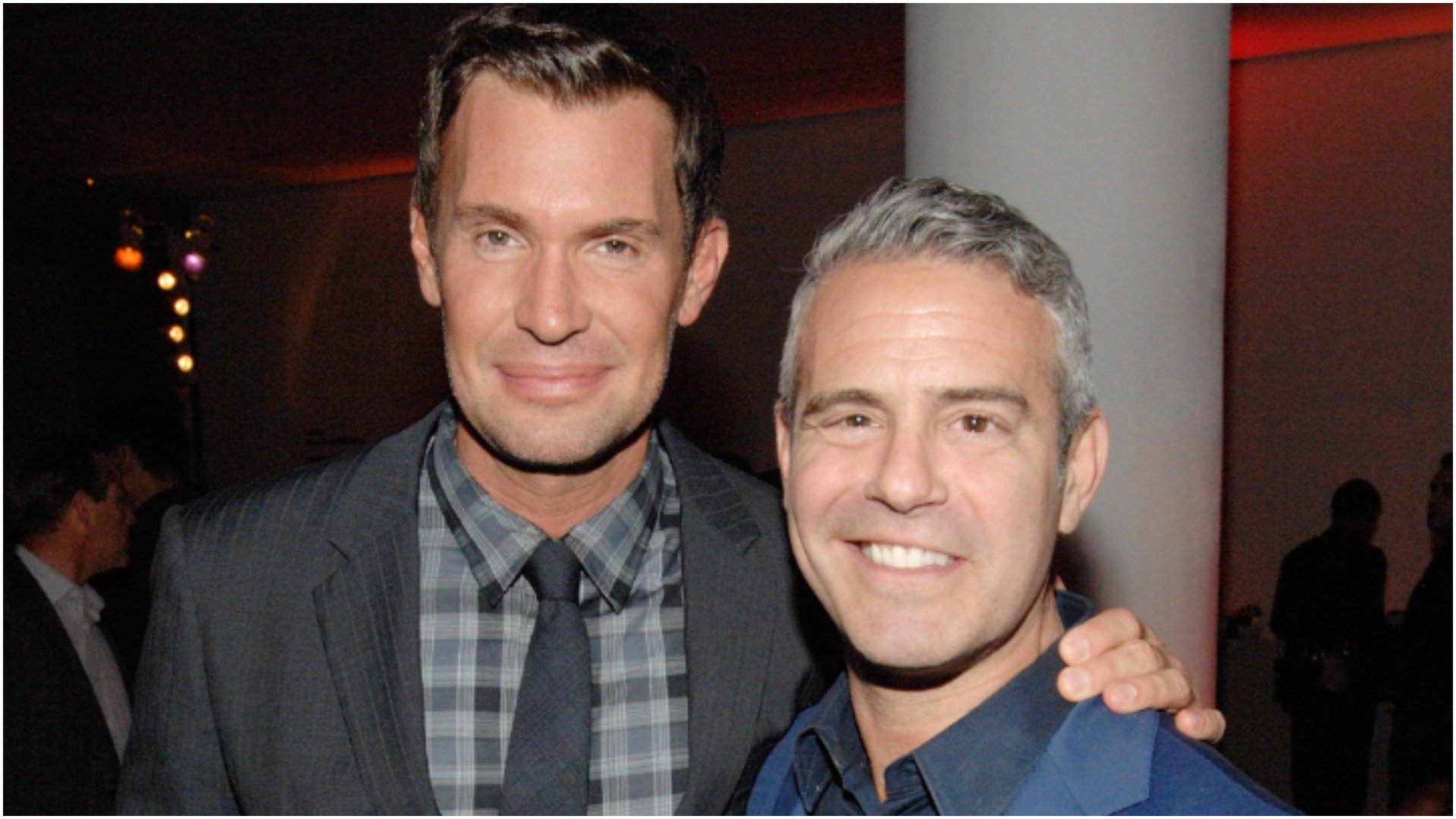 Jeff Lewis and Andy Cohen stop and smile for a photo during an event 