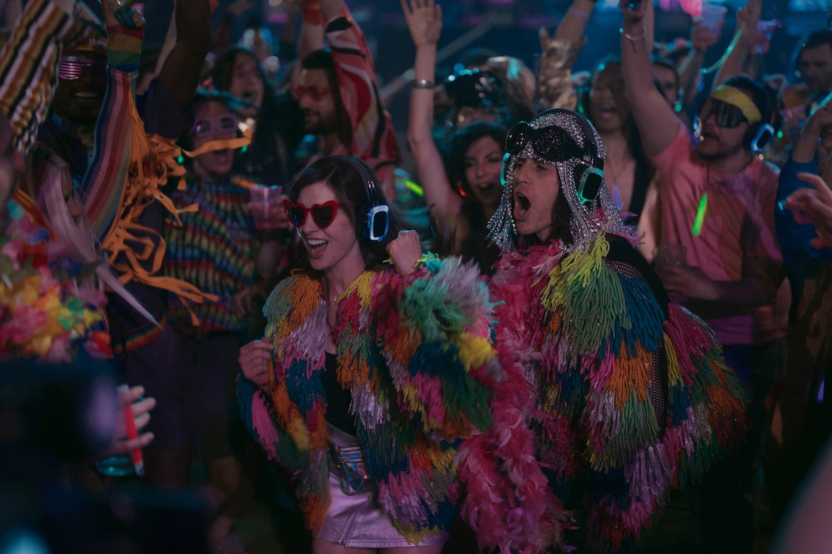 Anne Hathaway and Jared Let smile and dance wearing headphones in 'WeCrashed' Season 1 Episode 3: 'Summer Camp'