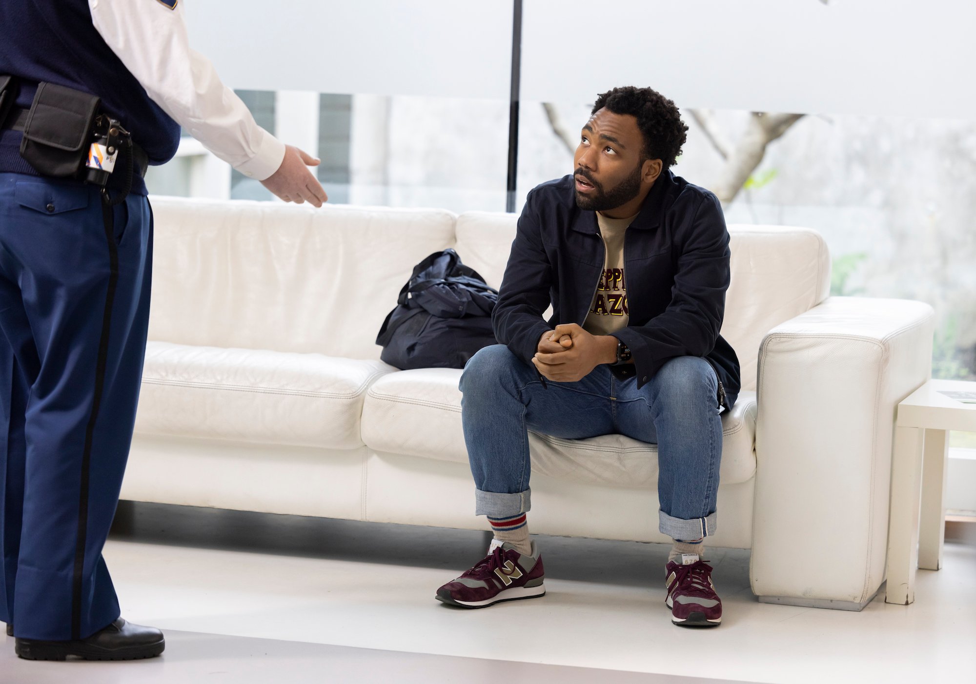 'Atlanta' Season 3: Donald Glover sits on a white sofa