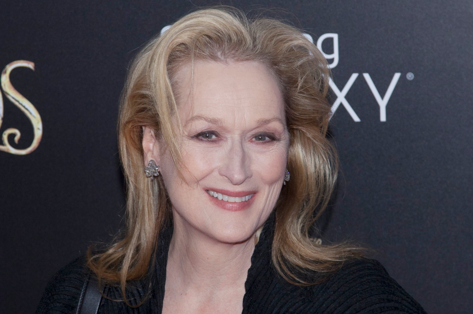 Audition queen Meryl Streep smiling in front of step and repeat