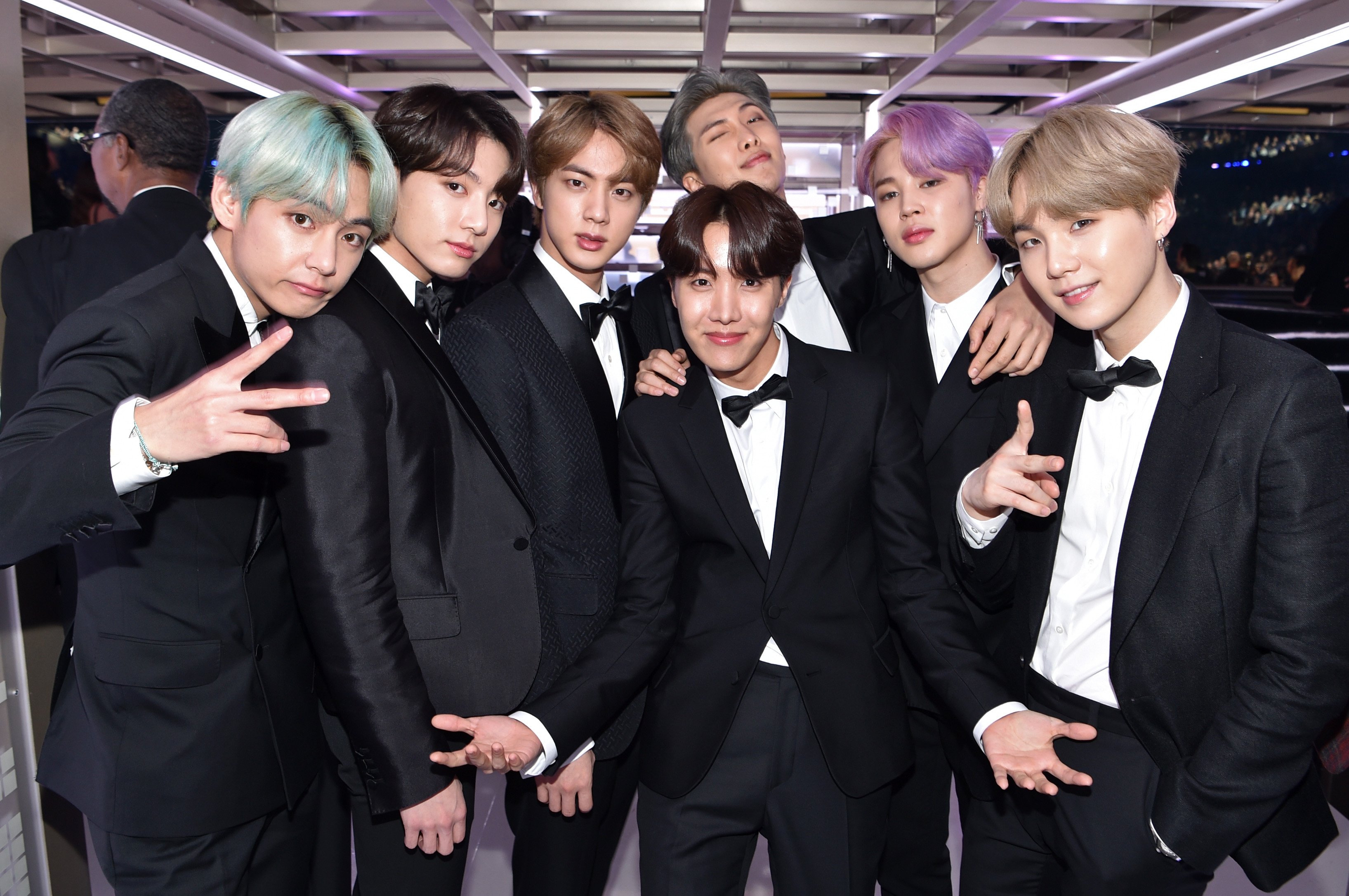 Members of BTS wearing tuxedos