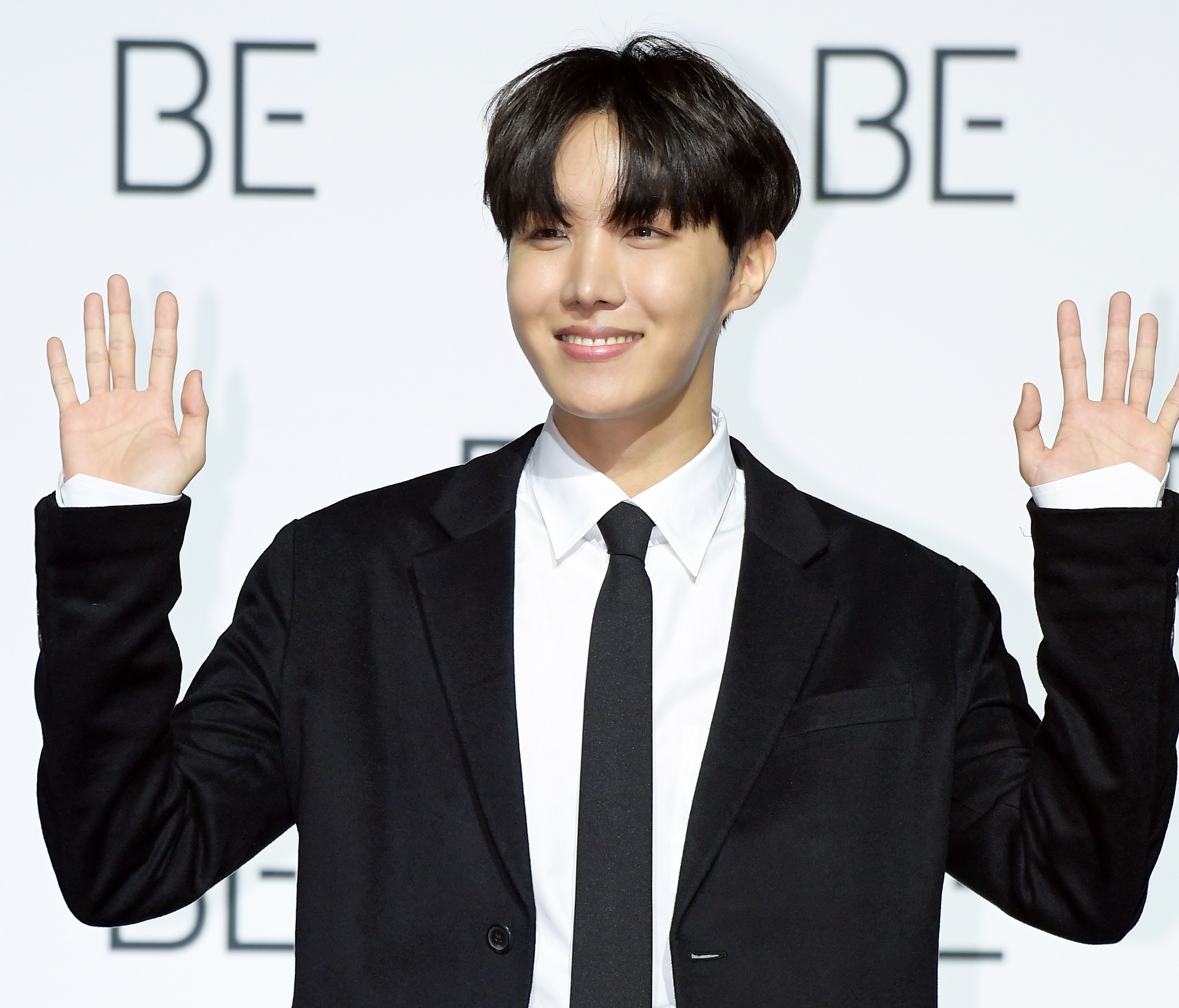 J-Hope of BTS raises his hands during BTS' press conference for their album 'BE'